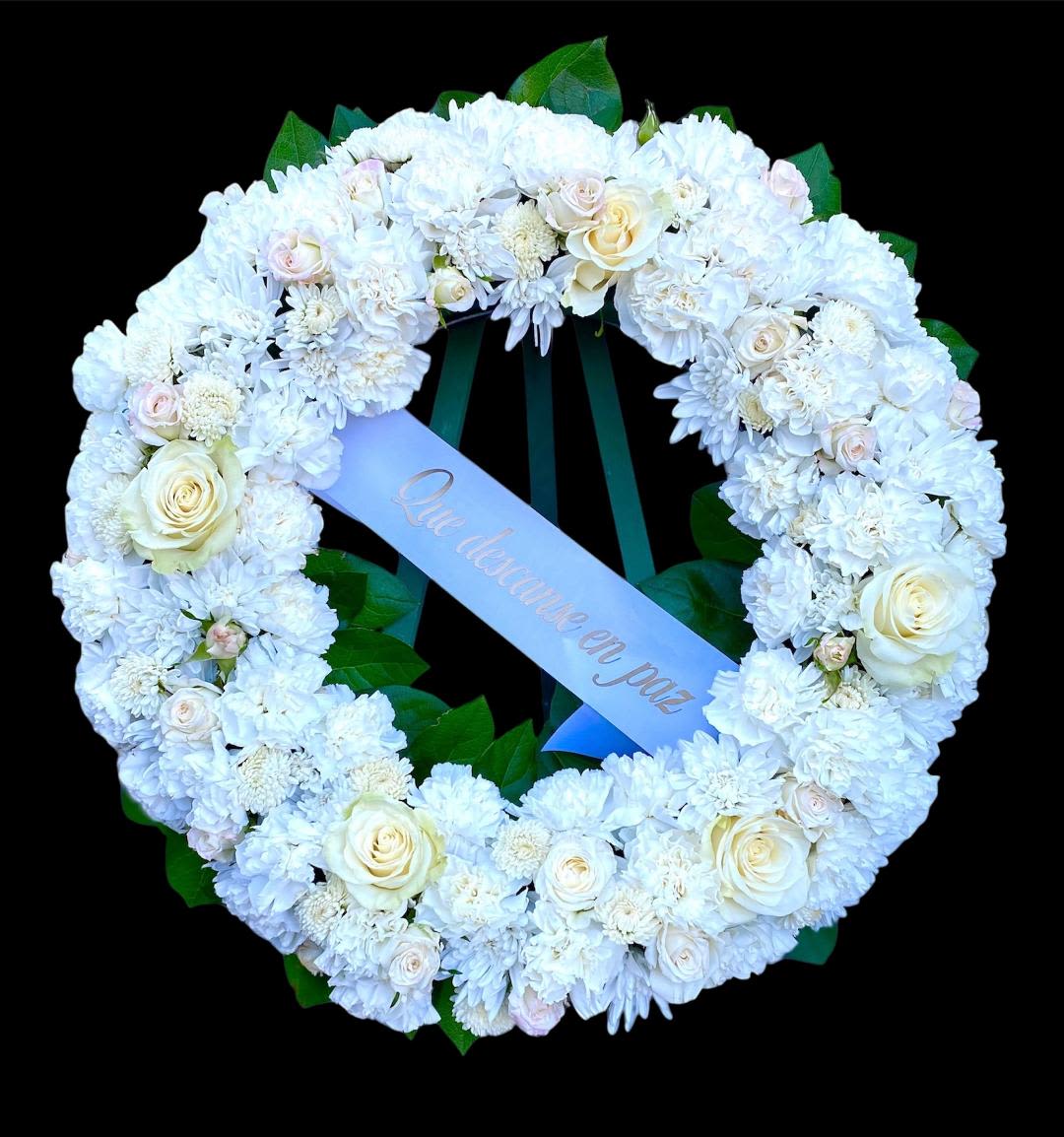 All White Sympathy Wreath All White Sympathy Wreath - This beautiful sympathy wreath is composed of all-white blooms including Roses, Spray Roses, Cushion Mums, Button Mums, and Carnations outlined in rich green Lemon Leaf. The wreath measures approx. 25" in dia. and comes with a personalized tribute ribbon.