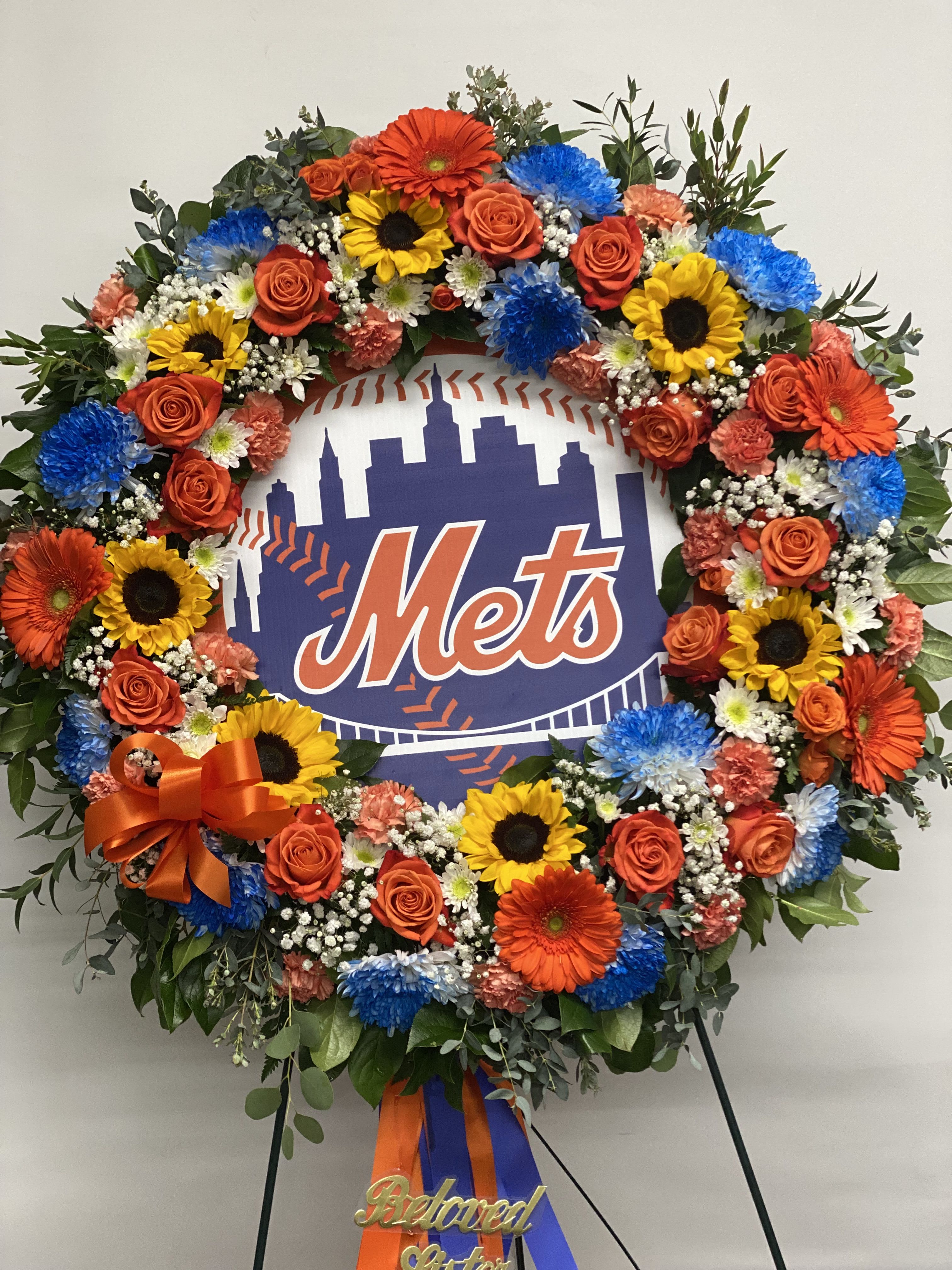 Eternally A Met’s Fan - This “uniquely ours” fan favorite sympathy tribute in honor of your #1 fan, will truly bring a smile and evoke happy memories of your loved one.   Each wreath is uniquely created especially for you and will vary slightly. Also available for Yankees, Rangers, Islanders, Jets, Giants