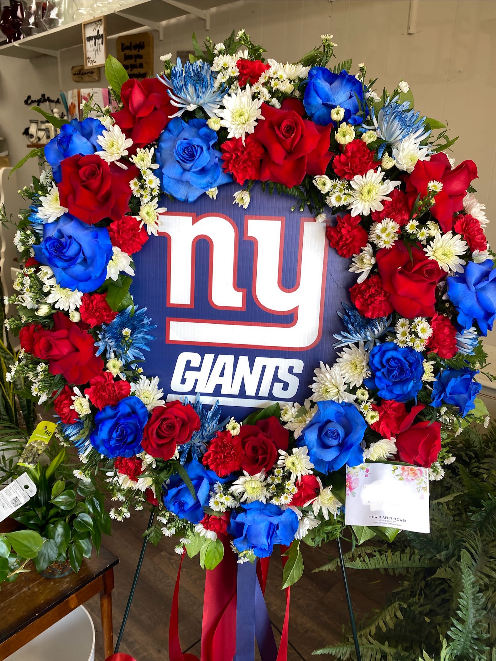 Forever A Football Fan - This “uniquely ours” fan favorite sympathy tribute in honor of your #1 fan, will truly bring a smile and evoke happy memories of your loved one.   Each wreath is uniquely created especially for you and will vary slightly. Also available for Mets, Yankees, Rangers, Islanders, Jets, Giants.  