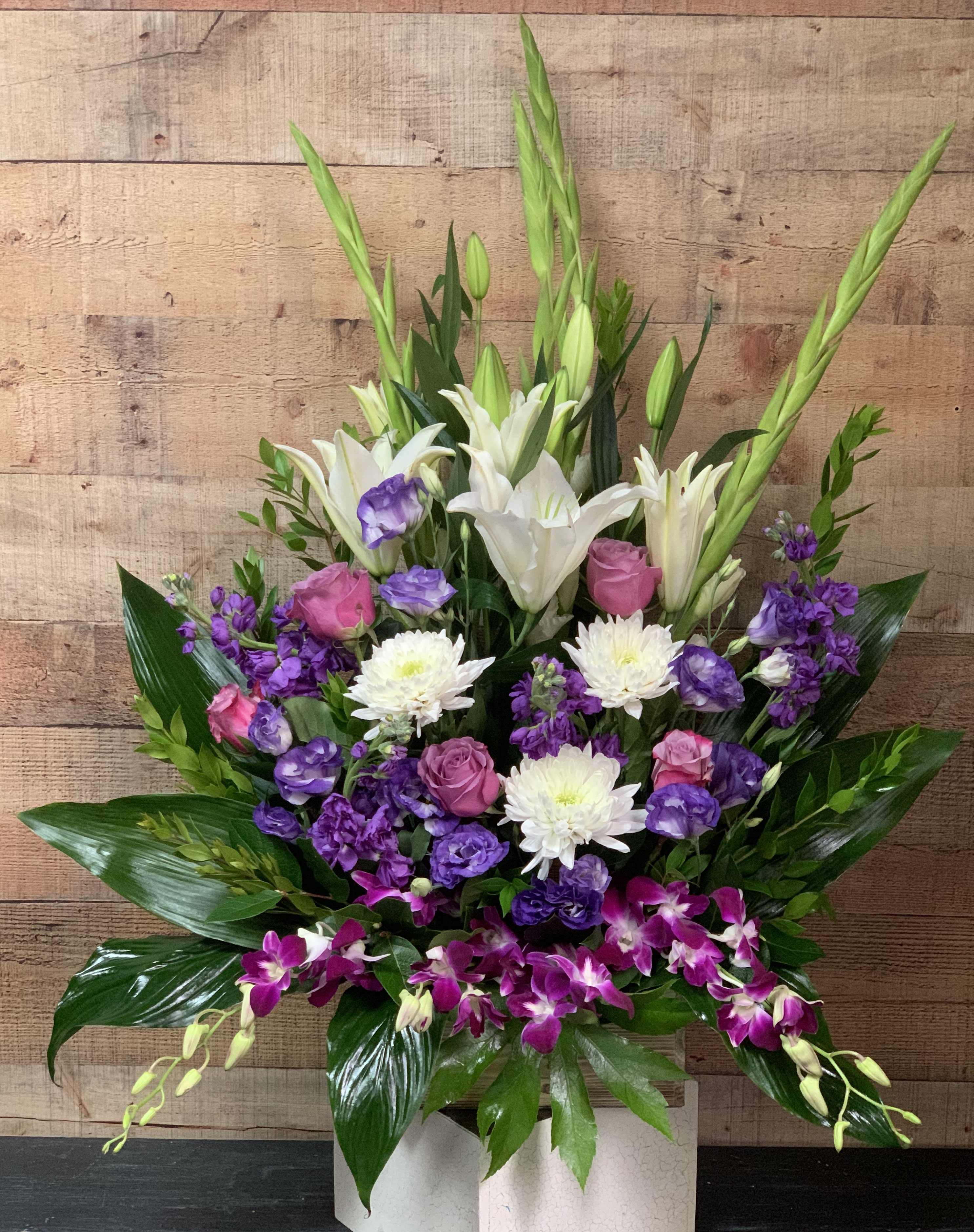 Purple Majesty Purple Majesty - An arrangement of purple, white, and lavender flowers. Includes, roses, dendrobium orchids, lilies,