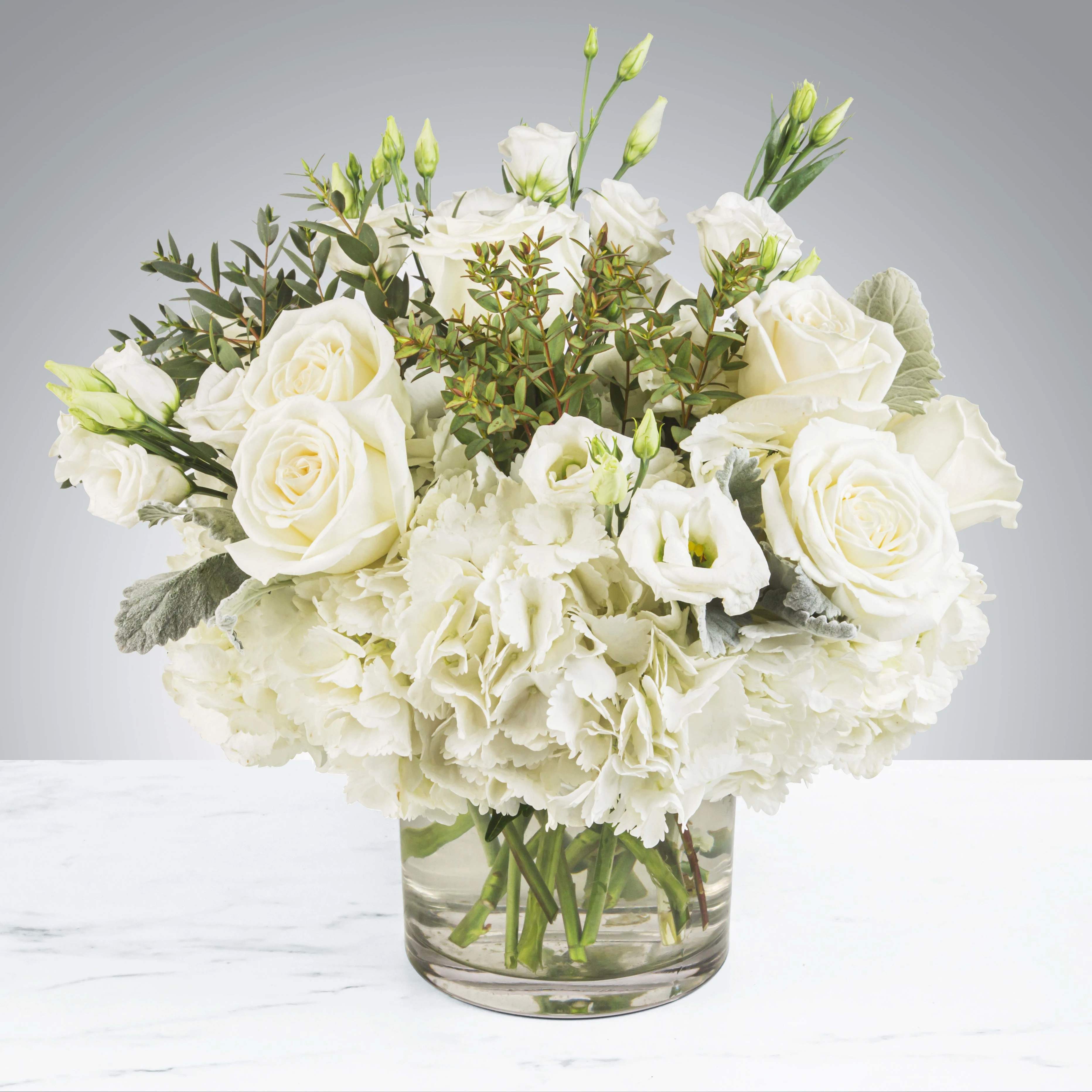 Cloud Nine by BloomNation™ Cloud Nine by BloomNation™ - New beginnings deserve flowers! This all white arrangement includes roses, lisianthus and hydrangeas. Cloud Nine by BloomNation™ is the perfect gift for celebrating a new year, a new baby, or a newly married couple. APPROXIMATE DIMENSIONS 15" W X 13" H