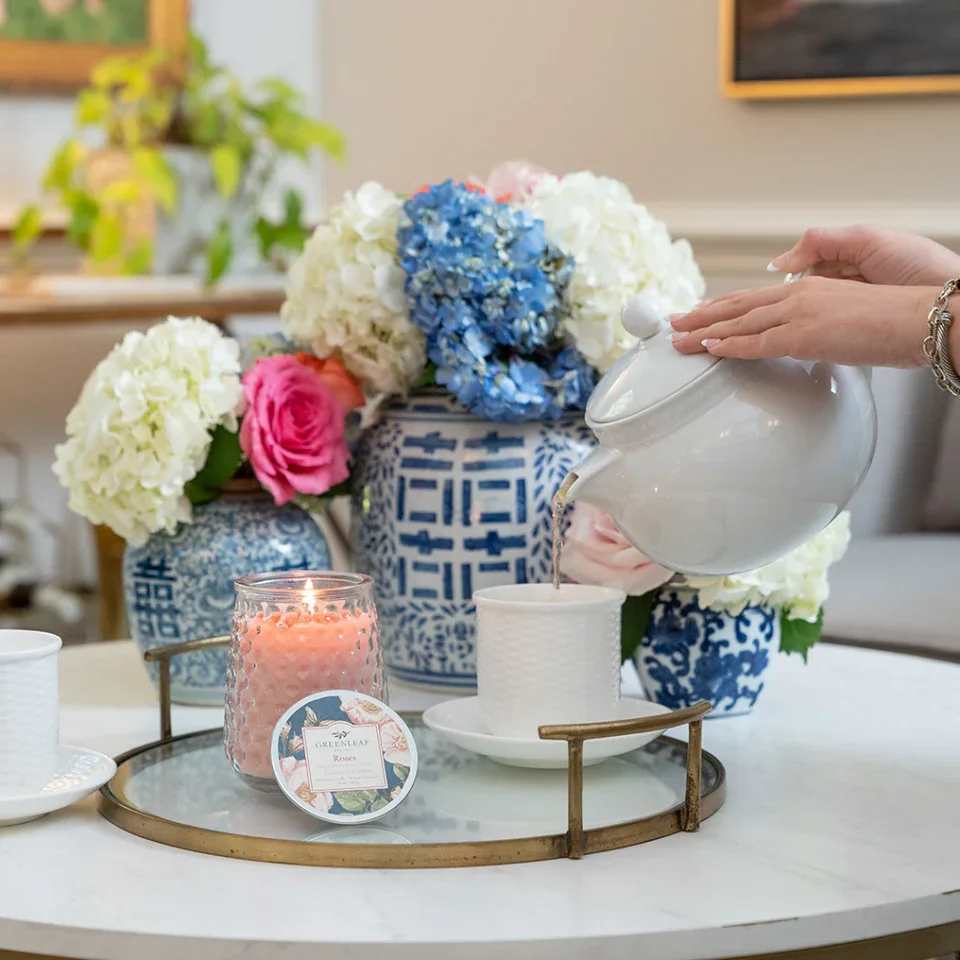 Roses Candle Roses Candle - With a clear, glass hobnail textured jar and a silver lid, our Signature Candle is the perfect match for any style. Fill your home with inviting Greenleaf fragrances that make any space feel cozy! What Makes it Special: Beautiful fragrance created in-house by a team of professional perfumers Fragrance: Roses Fragrance Family: Floral Fragrance Description: Fall in love all over again with the classic scent of Roses that embodies all things romantic and sweet. This sophisticated scent is truly lovely and sure to make you swoon every time you pass by. Use and Care: Burn within sight, Always trim wick to 1/4 in before lighting candle Keep candle on a level surface away from drafts Allow the wax to pool to the edge of the glass before extinguishing the flame Avoid dropping debris, such as wick trimmings, into the wax Extinguish the candle when your wax level reaches 1/4 inch