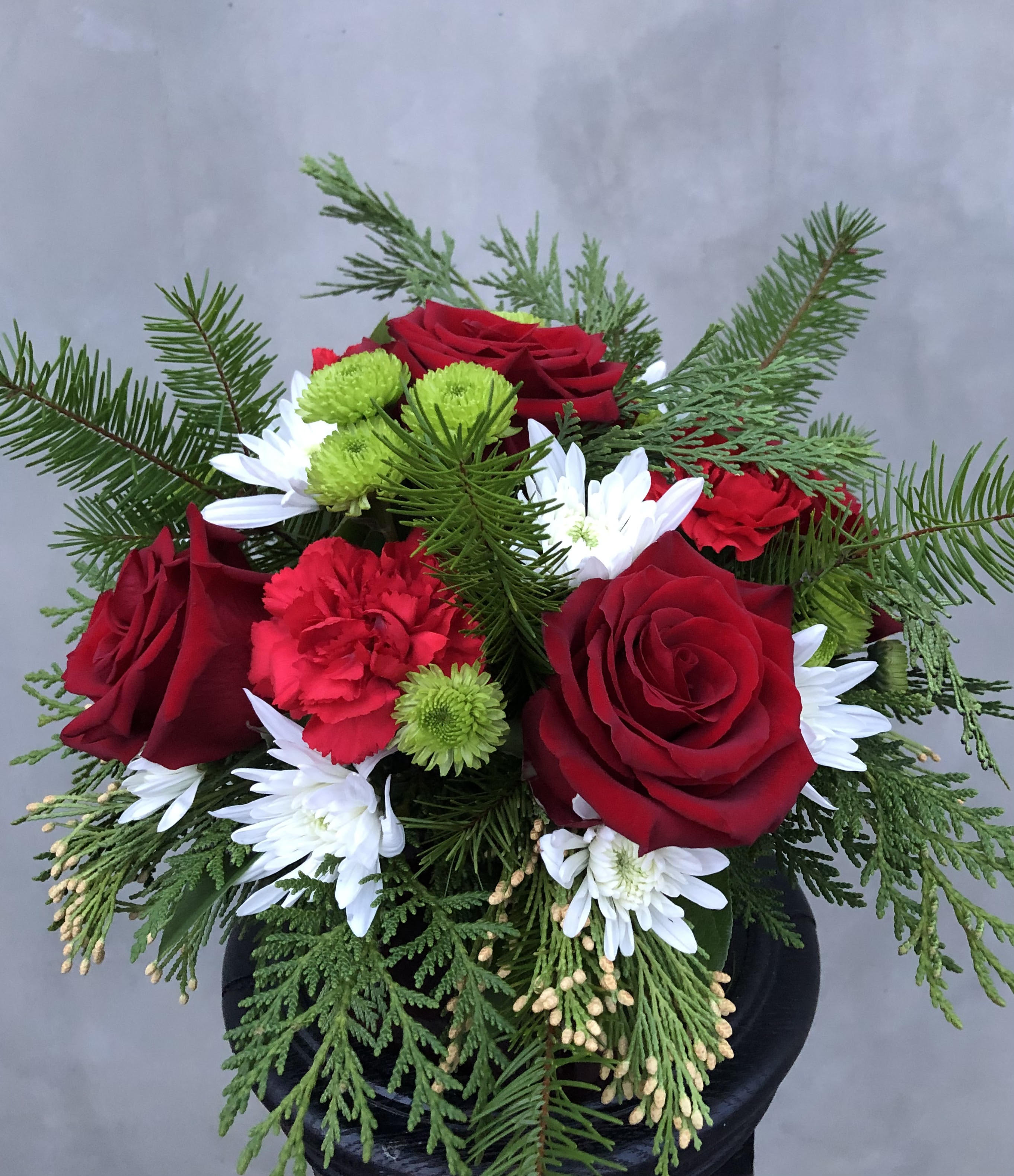 A Star has Born A Star has Born - Includes roses, chrysanthemum, carnations, and a mix of fir greenery all arranged in glass vase.