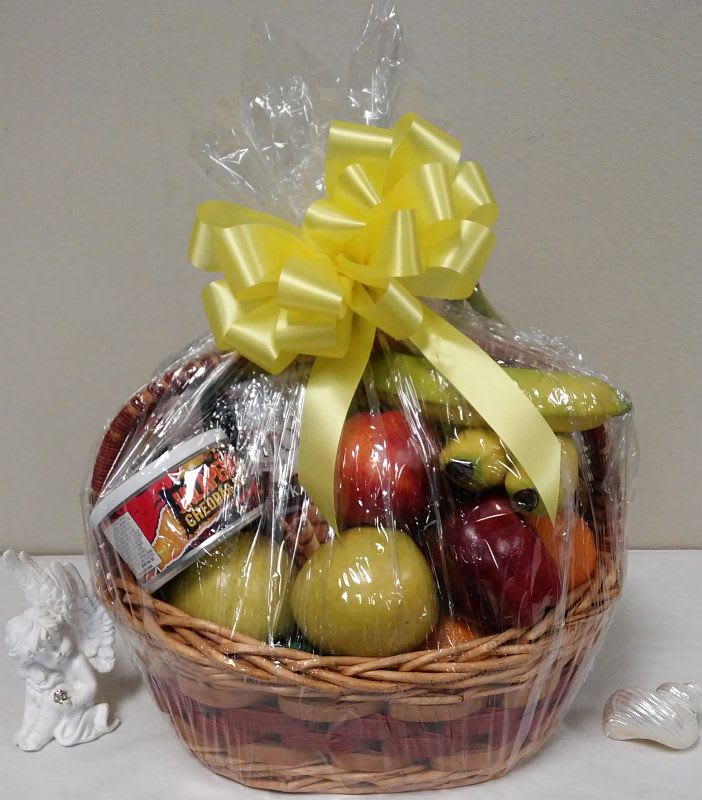 Fruit and Snack Basket - The basket contains items such as red and golden apples, pears, bananas, kiwis, oranges. Nuts, chocolates, cookies, crackers, and cheese are based on the larger size chosen.