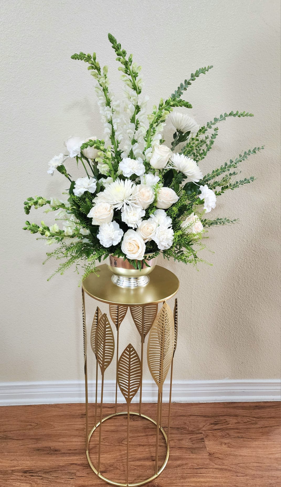 Pure Intentions - An all-white floral arrangement with carnations, snapdragons, roses, spidermums and greens, that will help you express your feelings when words are not enough.