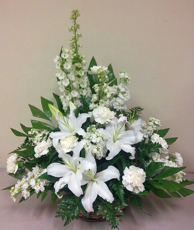 White Sympathy Basket White Sympathy Basket - The gracious basket is fulled with delphinium, stock oriental lilies and carnation with greenery.
