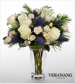 Vera Wang Winter Wonderland Bouquet Vera Wang Winter Wonderland Bouquet - FTD Winter Wonderland Bouquet with white roses, white spray roses and accents of Alpine blue thistle and pine. Presented in a glass vase.