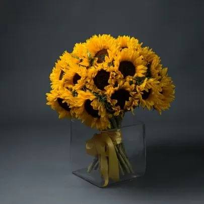 Suny day in the vases  - Brighten up a table, send get well wishes, or simply sprinkle sunshine on someone's day with this summer flower arrangement. Bold sunflowers are arranged in a glass bubble bowl with curly willow curled inside. Sunflowers steal the show in this simple arrangement. Also featured: green bupleurum, salal leaves and a curly willow inside the glass bubble bowl.  