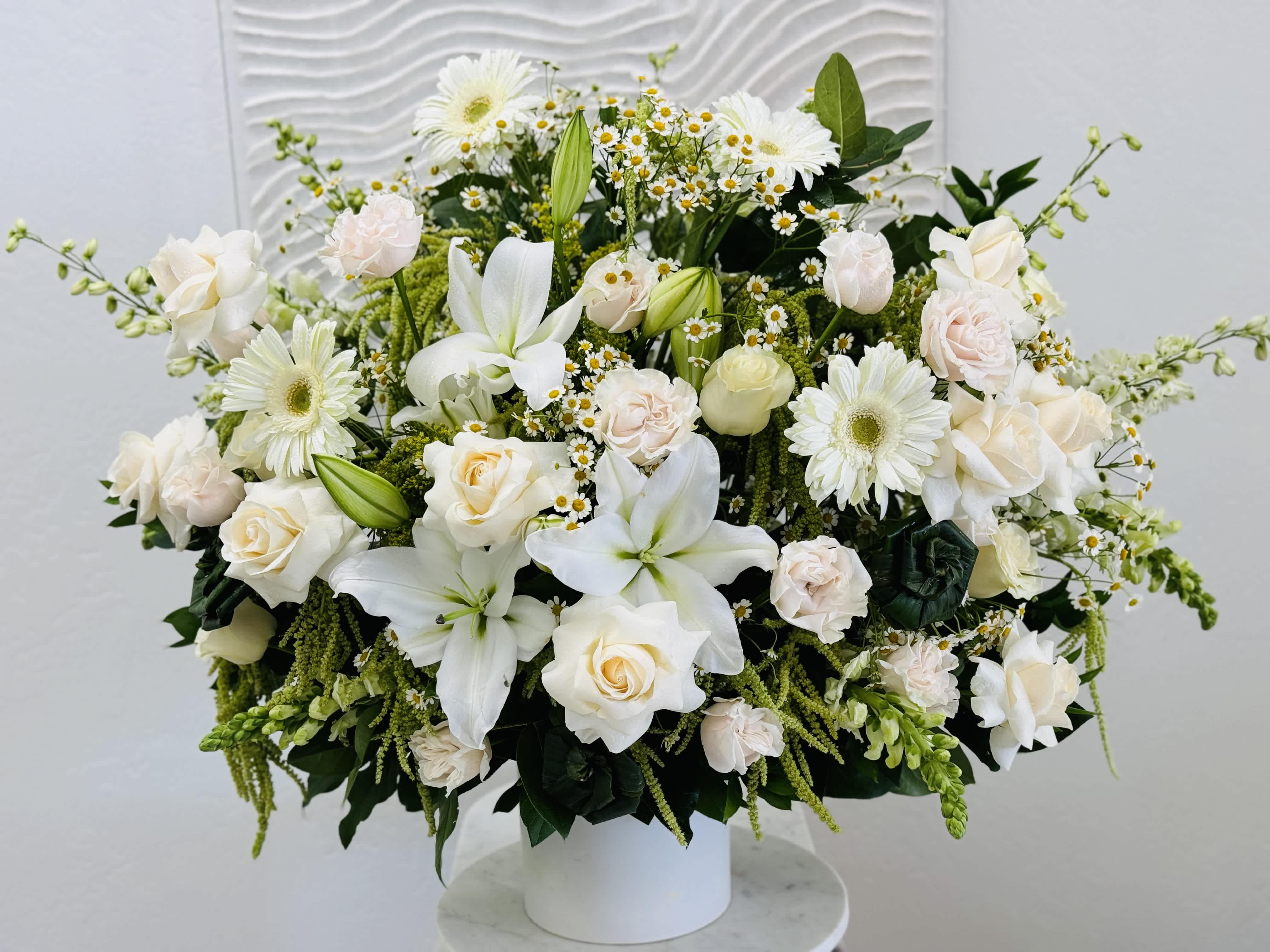 Altar Flower Arrangement White  - Altar Flower Arrangement White is vibrant, full of texture and fresh flowers in a ceramic vase.  It is tall and wide in size. Perfect for the service. 