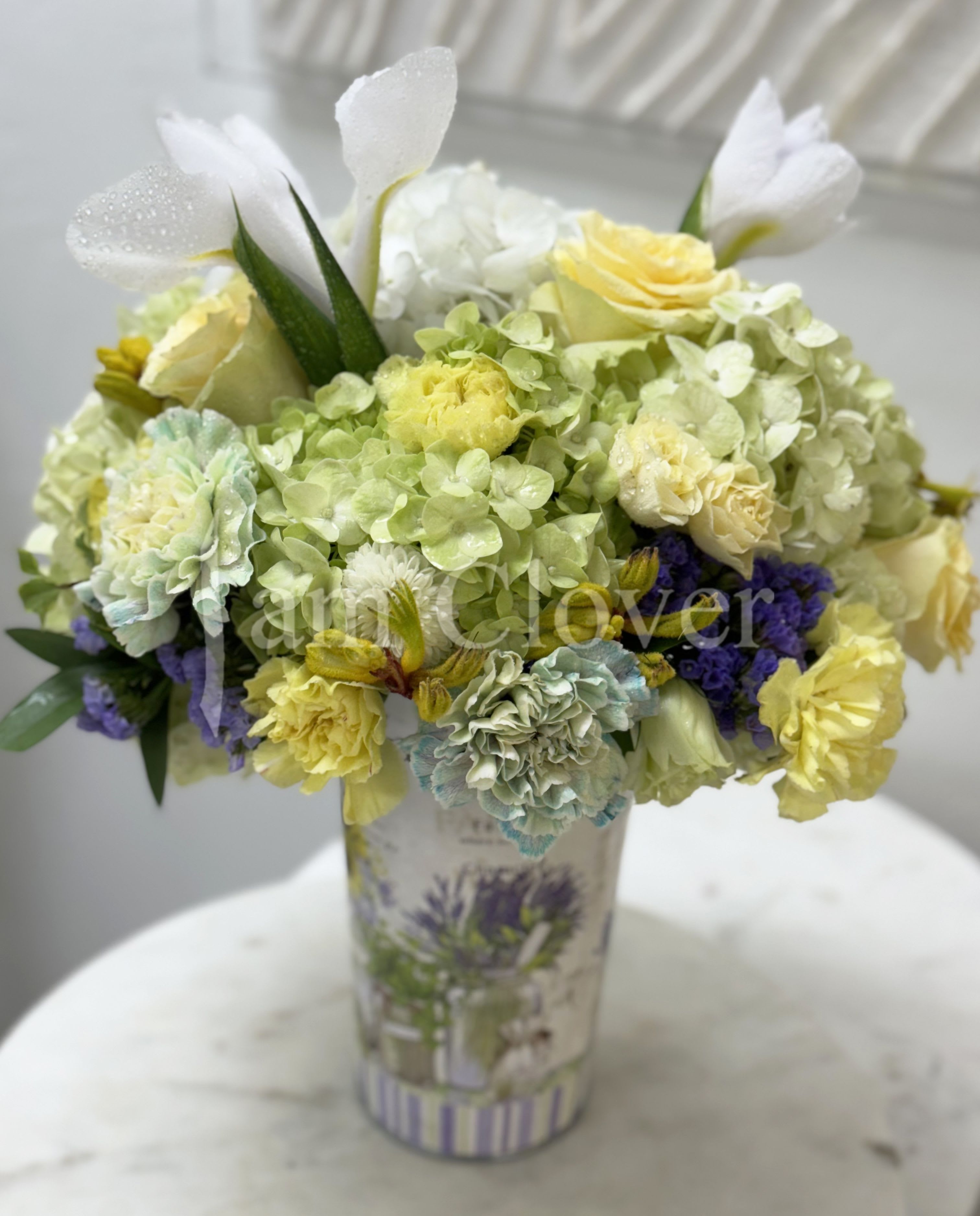 Yellow Butterfly  - This romantic arrangement has a light European fleur containing blush yellow and white roses, white hydrangeas, antique carnations and a butterfly- white iris.  Fulfill your floral needs at I Am Clover in Ramona, CA, and experience the difference in quality, freshness, and care that comes with ordering locally.   Disclosure: In some instances, our photo may represent an overall look and include a one-of-a-kind vase which cannot be exactly replicated. Occasional substitutions of flowers and/or containers happen due to weather, seasonality and market conditions. We will ensure that the style, theme and color scheme of your arrangement is preserved and will only substitute items of equal value or higher value.  Delivery: 2:30pm - 6:30pm Same Day Orders may take at least 6 hours to process and deliver Morning and Specific Delivery Time Requests:  will be charged a $15 convenience fee. Specific delivery times are acknowledged and we will do our best to accommodate, however we cannot guarantee on time delivery due to unforeseen events.  Gate Codes are mandatory for our delivery drivers to enter residential or commercial buildings. Our drivers will only wait five minutes outside the gate for a callback. If a driver has to leave a property, the delivery is reassigned for the next day and may charge an additional delivery fee.   Thank you!