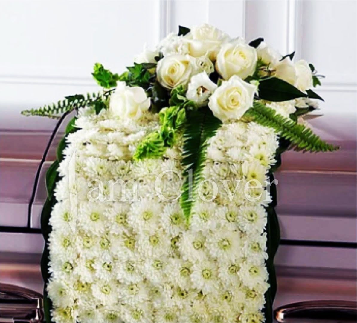 Casket Flower Blanket  - This is out of ordinary casket blanket, is something definitely special you can get from a local florist I am Clover in Ramona, CA. It is a beautiful piece created with pop poms, daisies, roses and lilies and also other flowers in stock. Any variations in color or style are possible upon request.   Fulfill your floral needs at I Am Clover in Ramona, CA, and experience the difference in quality, freshness, and care that comes with ordering locally.   Disclosure: In some instances, our photo may represent an overall look and include a one-of-a-kind vase which cannot be exactly replicated. Occasional substitutions of flowers and/or containers happen due to weather, seasonality and market conditions. We will ensure that the style, theme and color scheme of your arrangement is preserved and will only substitute items of equal value or higher value.  Delivery: 2:30pm - 6:30pm Same Day Orders may take at least 6 hours to process and deliver Morning and Specific Delivery Time Requests:  will be charged a $15 convenience fee. Specific delivery times are acknowledged and we will do our best to accommodate, however we cannot guarantee on time delivery due to unforeseen events.  Gate Codes are mandatory for our delivery drivers to enter residential or commercial buildings. Our drivers will only wait five minutes outside the gate for a callback. If a driver has to leave a property, the delivery is reassigned for the next day and may charge an additional delivery fee.   Thank you!