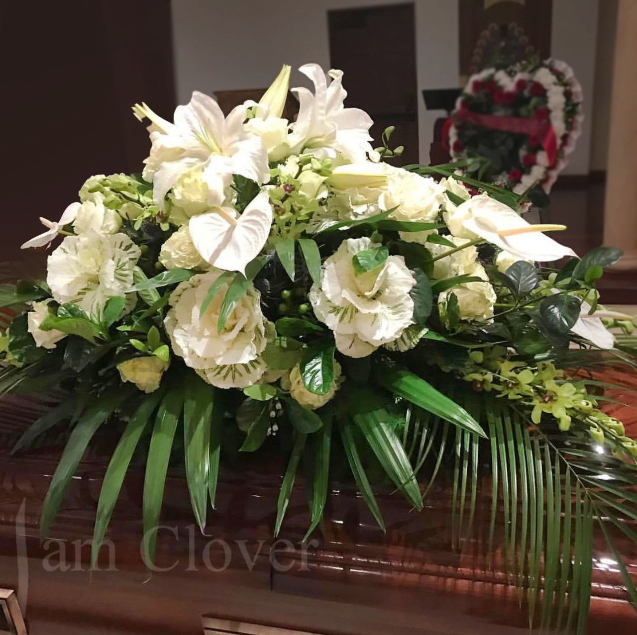 White and Green Casket Spray - White and Green Casket Spray This elegant casket spray is designed to honor a loved one’s memory with grace and sophistication. Featuring serene white blooms paired with lush green foliage, this tasteful arrangement embodies peace and heartfelt sympathy. Perfect for a funeral service, this tribute reflects the beauty of a life remembered with love and respect.  Let me know if you’d like any customization!   Fulfill your floral needs at I Am Clover in Ramona, CA, and experience the difference in quality, freshness, and care that comes with ordering locally.   Disclosure: Occasional substitutions of flowers happen due to weather, seasonality and market conditions. We will ensure that the style, theme and color scheme of your arrangement is preserved and will only substitute items of equal value or higher value.  Delivery: 2:30pm - 6:30pm Same Day Orders may take at least 6 hours to process and deliver Morning and Specific Delivery Time Requests:  will be charged a $15 convenience fee. Specific delivery times are acknowledged and we will do our best to accommodate, however we cannot guarantee on time delivery due to unforeseen events.  Gate Codes are mandatory for our delivery drivers to enter residential or commercial buildings. Our drivers will only wait five minutes outside the gate for a callback. If a driver has to leave a property, the delivery is reassigned for the next day and may charge an additional delivery fee. 