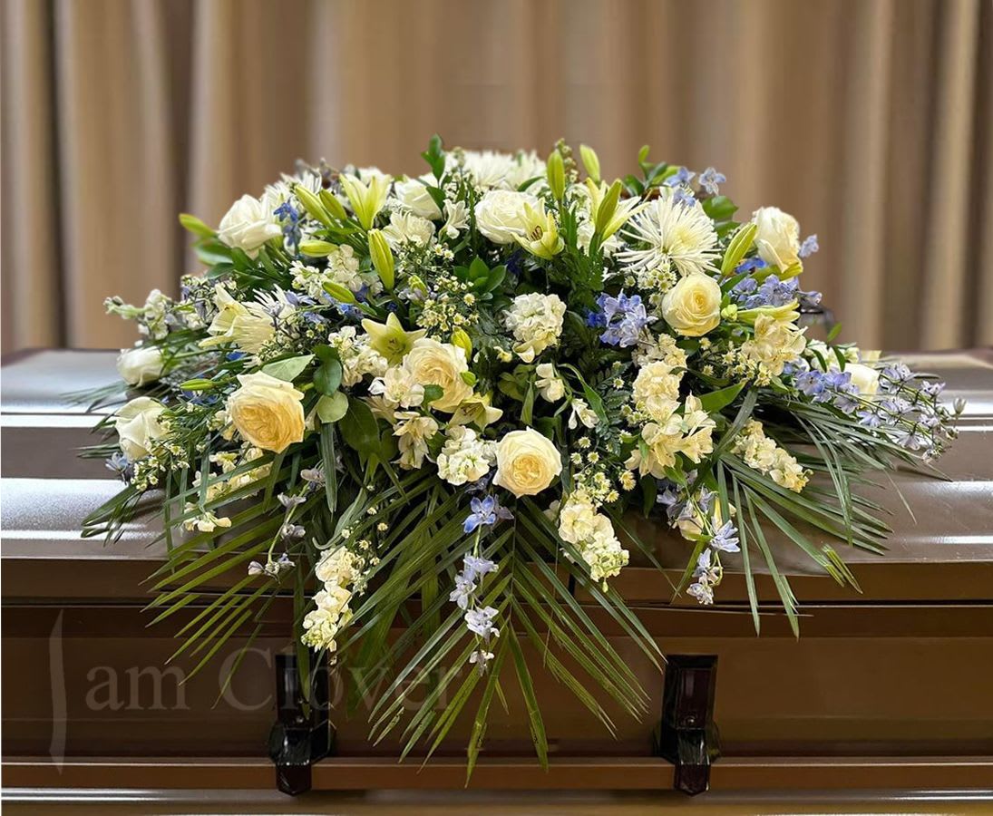 Blue and White Casket Spray - This casket spray is composed with a variety of blue and white flowers. Sizes Small, Medium or Large  Fulfill your floral needs at I Am Clover in Ramona, CA, and experience the difference in quality, freshness, and care that comes with ordering locally.   Disclosure: Occasional substitutions of flowers happen due to weather, seasonality and market conditions. We will ensure that the style, theme and color scheme of your arrangement is preserved and will only substitute items of equal value or higher value.  Delivery: 2:30pm - 6:30pm Same Day Orders may take at least 6 hours to process and deliver Morning and Specific Delivery Time Requests:  will be charged a $15 convenience fee. Specific delivery times are acknowledged and we will do our best to accommodate, however we cannot guarantee on time delivery due to unforeseen events.  Gate Codes are mandatory for our delivery drivers to enter residential or commercial buildings. If you don’t know the gate code for a delivery, please contact the recipient and provide us with it or our driver can contact the recipient before beginning a delivery route to obtain the code. Our drivers will only wait five minutes outside the gate for a callback. If a driver has to leave a property, the delivery is reassigned for the next day and may charge an additional delivery fee.   Thank you! 