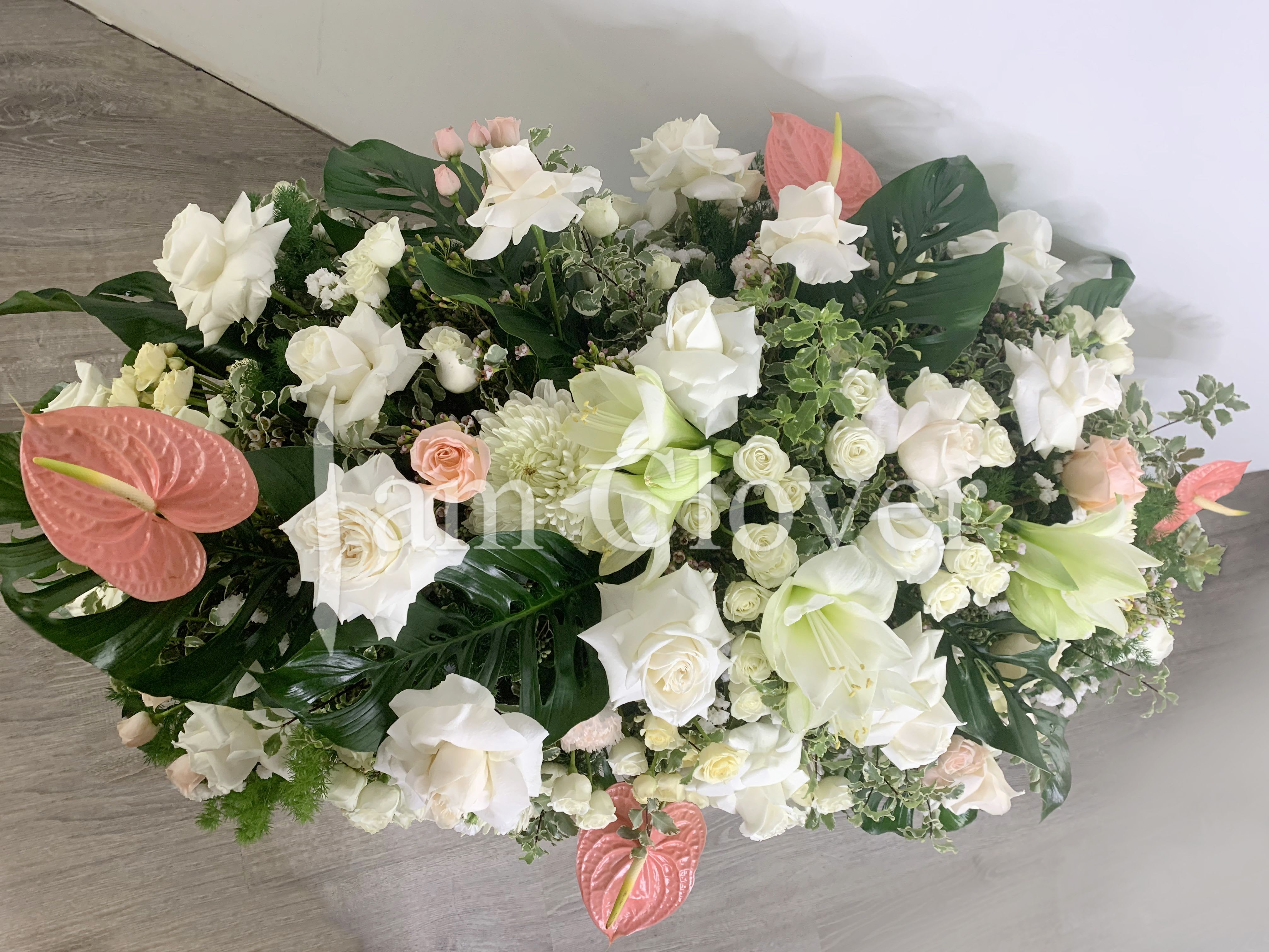 White and Peach Casket Spray - This beautiful and soothing spray is composed with a variety of white and peach flowers, symbolizing warmth, grace, and the enduring love of those left behind.  Fulfill your floral needs at I Am Clover in Ramona, CA, and experience the difference in quality, freshness, and care that comes with ordering locally.   Disclosure: Occasional substitutions of flowers happen due to weather, seasonality and market conditions. We will ensure that the style, theme and color scheme of your arrangement is preserved and will only substitute items of equal value or higher value.  Delivery: 2:30pm - 6:30pm Same Day Orders may take at least 6 hours to process and deliver Morning and Specific Delivery Time Requests:  will be charged a $15 convenience fee. Specific delivery times are acknowledged and we will do our best to accommodate, however we cannot guarantee on time delivery due to unforeseen events.  Gate Codes are mandatory for our delivery drivers to enter residential or commercial buildings. If you don’t know the gate code for a delivery, please contact the recipient and provide us with it or our driver can contact the recipient before beginning a delivery route to obtain the code. Our drivers will only wait five minutes outside the gate for a callback. If a driver has to leave a property, the delivery is reassigned for the next day and may charge an additional delivery fee.   Thank you! 