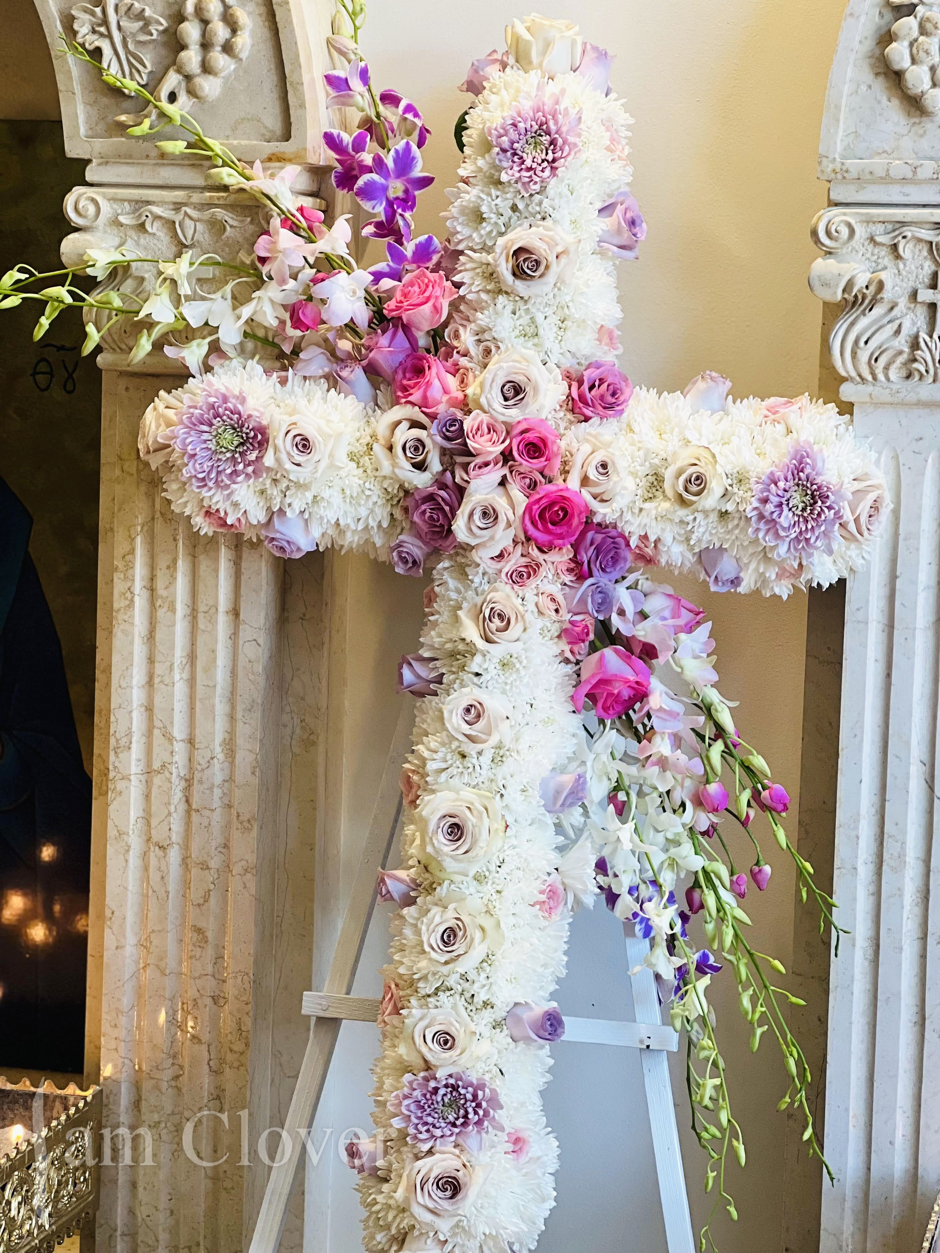 Zinetta's Cross - This stunning cross will express the love and legacy just the way you wanted.   Fulfill your floral needs at I Am Clover in Ramona, CA, and experience the difference in quality, freshness, and care that comes with ordering locally.   Disclosure: Occasional substitutions of flowers happen due to weather, seasonality and market conditions. We will ensure that the style, theme and color scheme of your arrangement is preserved and will only substitute items of equal value or higher value.  Delivery: 2:30pm - 6:30pm Same Day Orders may take at least 6 hours to process and deliver Morning and Specific Delivery Time Requests:  will be charged a $15 convenience fee. Specific delivery times are acknowledged and we will do our best to accommodate, however we cannot guarantee on time delivery due to unforeseen events.  Gate Codes are mandatory for our delivery drivers to enter residential or commercial buildings. If you don’t know the gate code for a delivery, please contact the recipient and provide us with it or our driver can contact the recipient before beginning a delivery route to obtain the code. Our drivers will only wait five minutes outside the gate for a callback. If a driver has to leave a property, the delivery is reassigned for the next day and may charge an additional delivery fee.   Thank you!