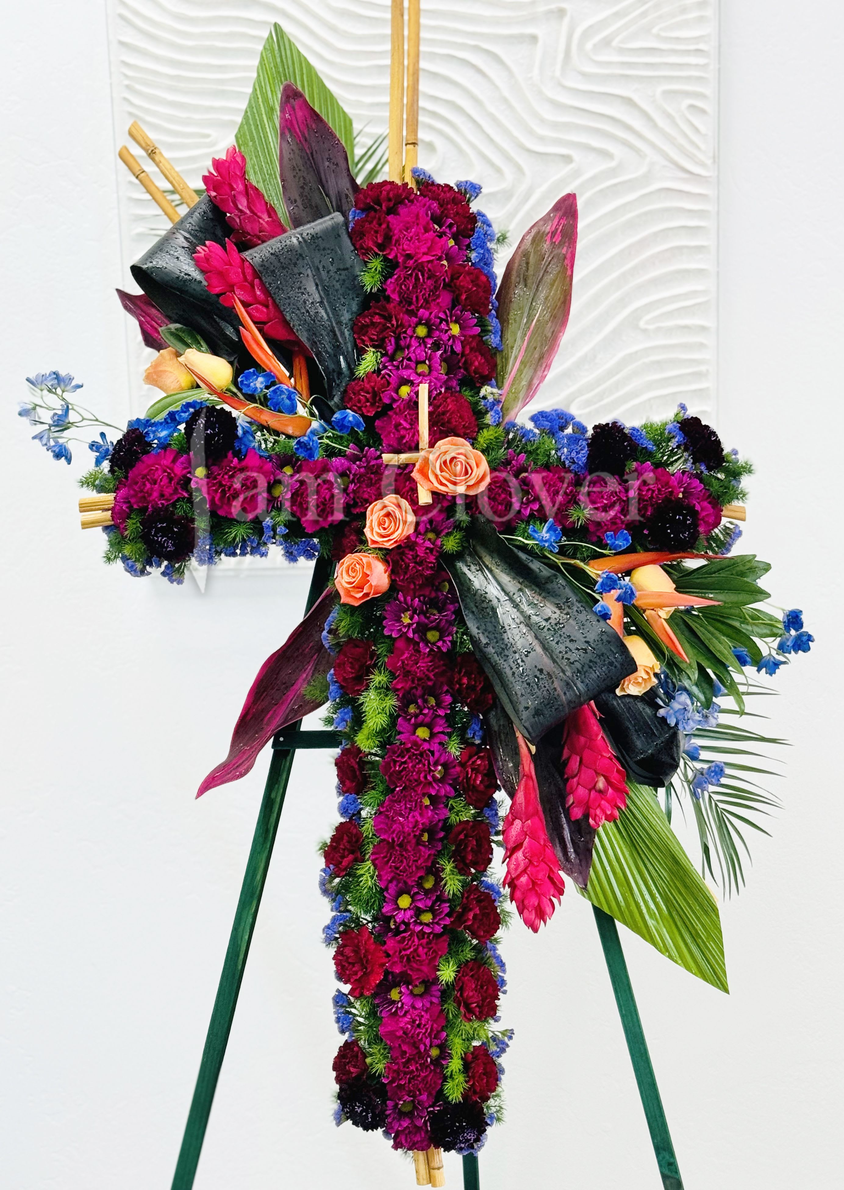 Tropical Flowers Cross  - A beautiful tropical flower standing cross is a vibrant and striking tribute. Fulfill your floral needs at I Am Clover in Ramona, CA, and experience the difference in quality, freshness, and care that comes with ordering locally. By choosing a local florist, you’re ensuring that each bloom is handpicked at the peak of its beauty, arriving at your doorstep or event in perfect condition. I Am Clover works with the finest, seasonal blooms, meaning your arrangement is as fresh as possible—often sourced directly from nearby growers. 