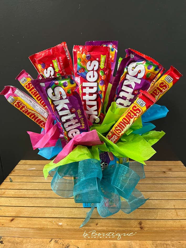 Candy Bouquet- Primarily chewy candys Candy Bouquet- Primarily chewy candys - Mix of 4 box candies as the base, various FULL size Candies on sticks. Filled to Value. Candies that may be included but not limited to: Skittles, starbursts, Mike N Ikes, goodnplenty, lemonheads, Hershey's, Snickers, Twix, Reese's, Musketeers, Buttercups, Dots, Heath, Kit Kat, Milkyway, M&M.. Please call 509-922-6300 for a custom built bouquet