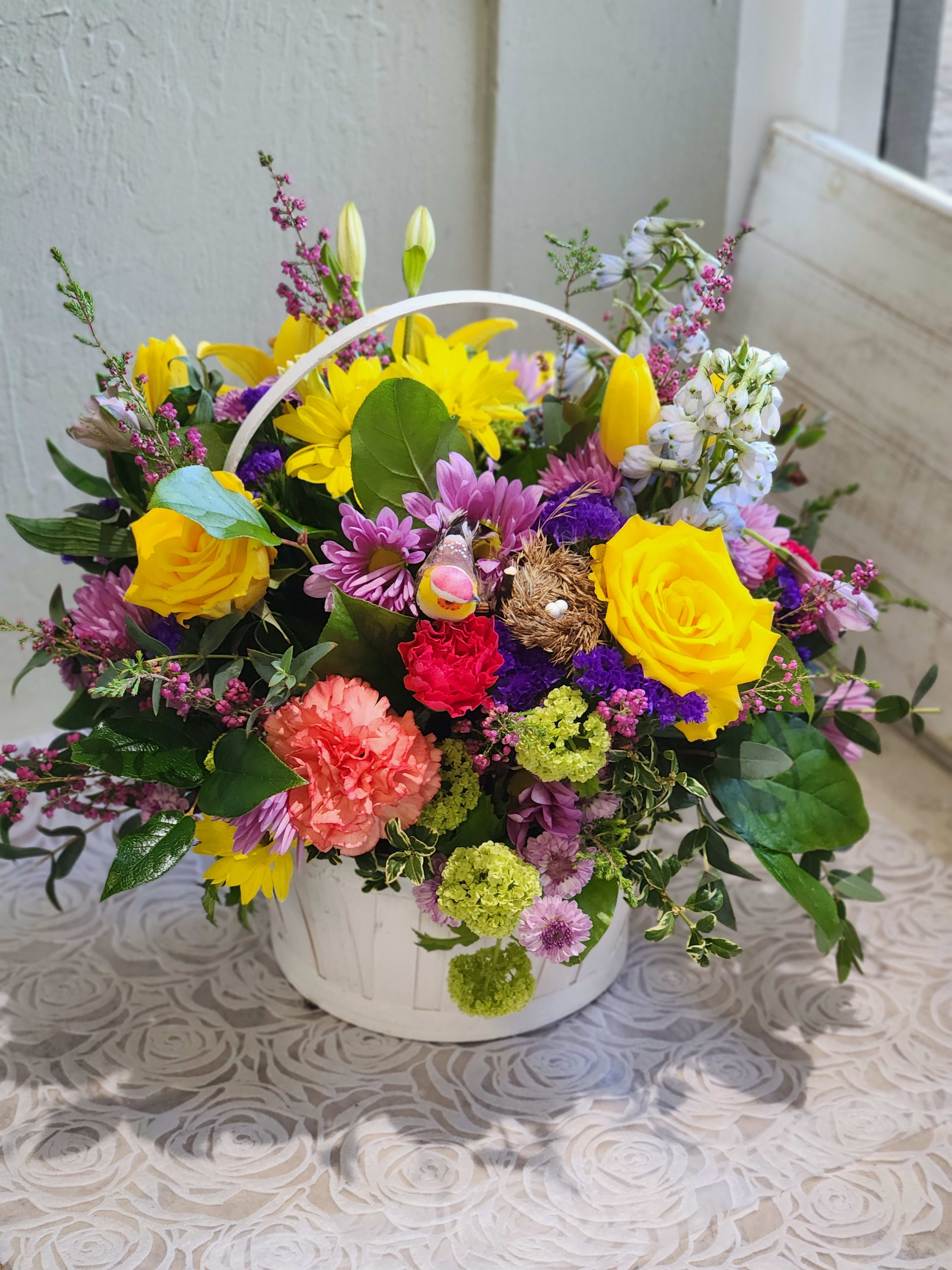 Sophia Arrangement  - A cute spring basket with bright colors accented with curly willow and a cute little bird. Baskets will vary depending on inventory. Picture is Premium size 