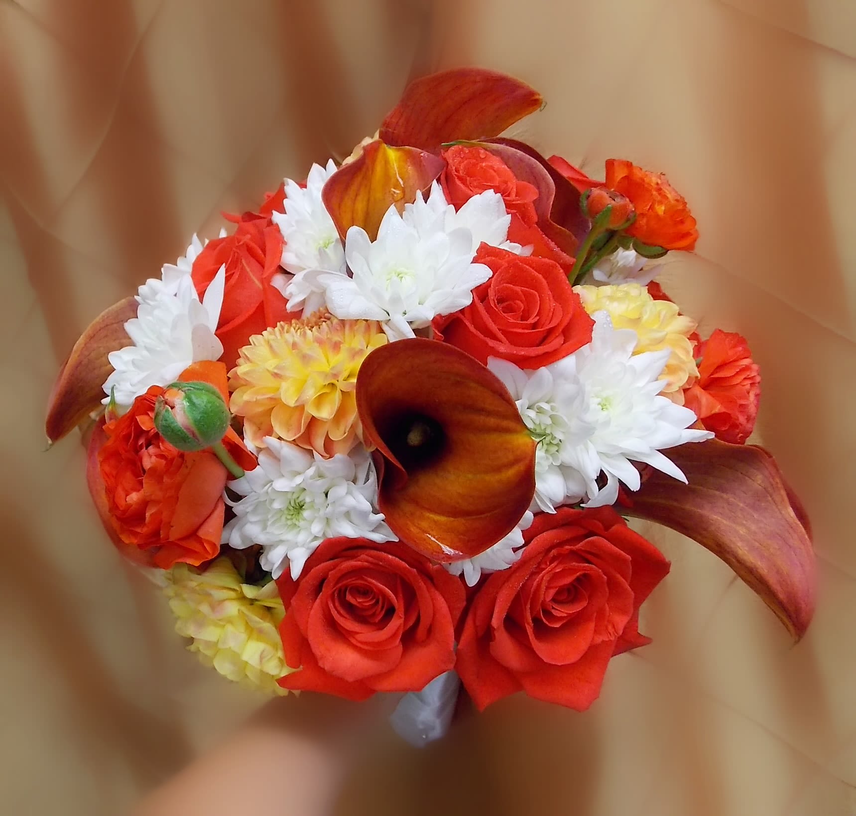 SUNSET BRIDAL BQT - ORANGE ROSES, ORANGE MINI CALLA LILIES, WHITE CUSHION POMS