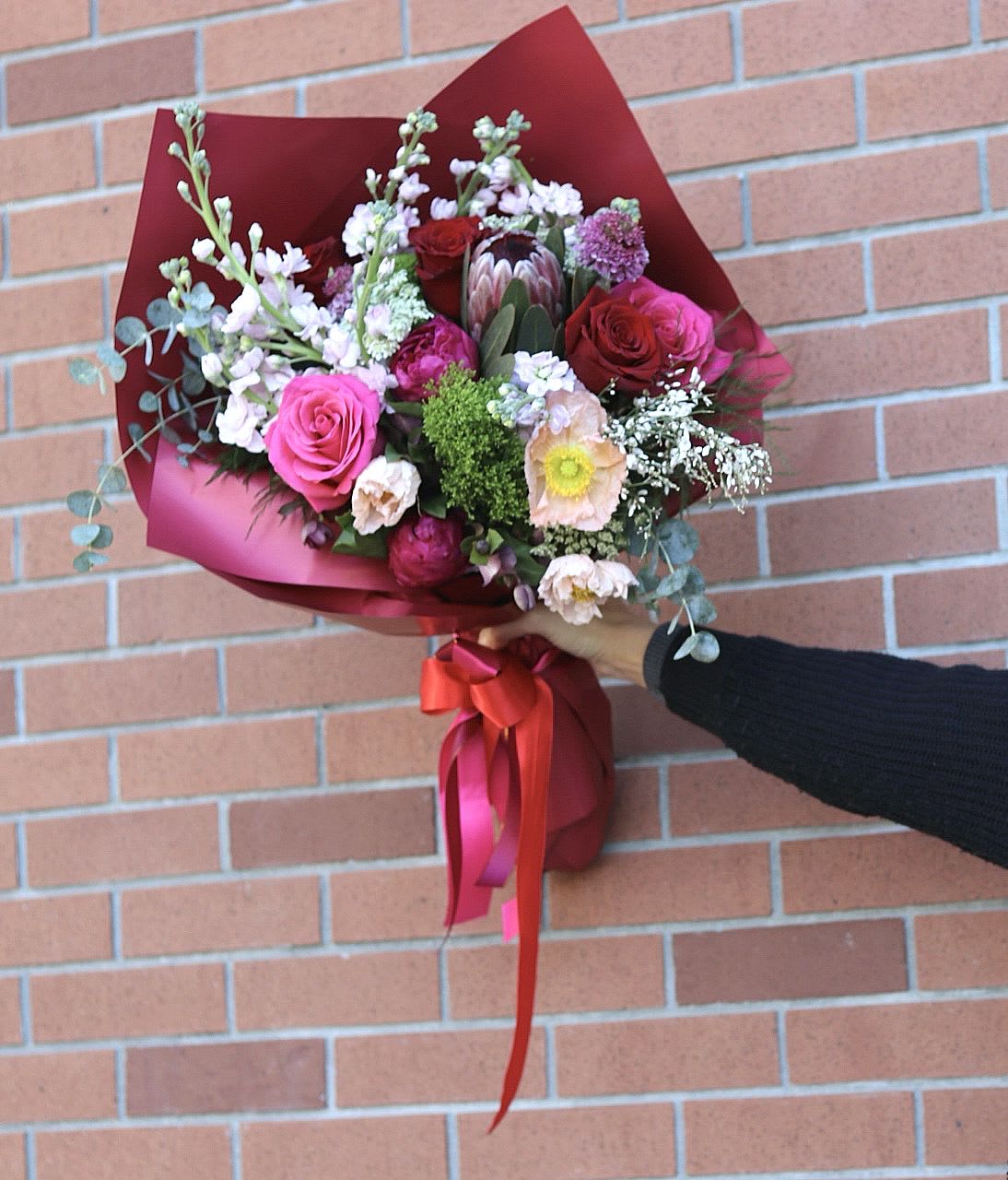 Designer’s Choice Fresh Wrapped Bouquet  - Weekly fresh exquisite flowers hand picked and selected by the designer. Freshest blooms including premium flowers only. Wrapped and accented with a bow. 
