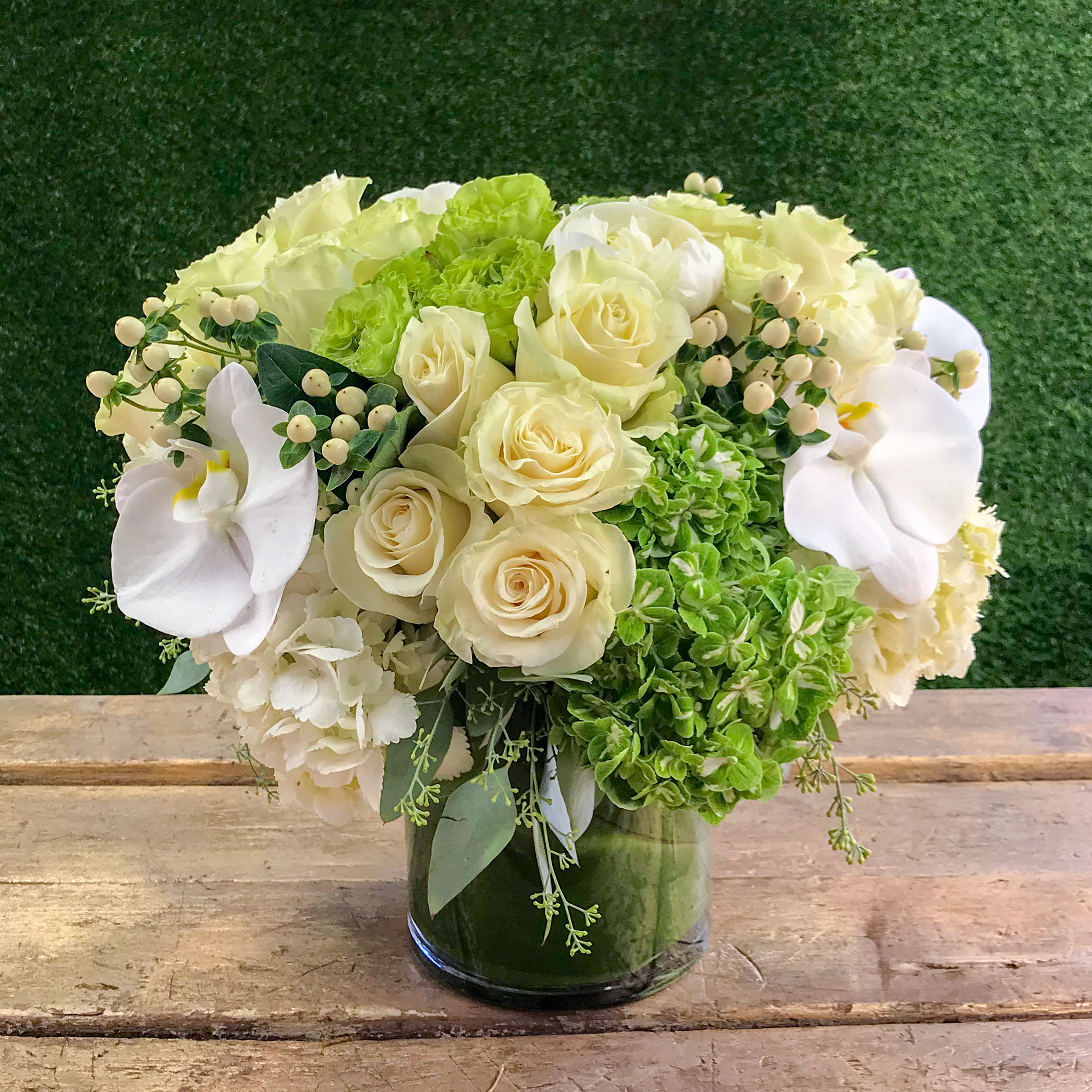 Bayside - Let in some light in your life with this collection of white/green hydrangeas, white/green roses, white orchids, and coffee beans. This refreshing arrangement sits in an 8&quot; x 6&quot; vase.It's that feeling of sunshine on a clear blue day captured in all its floral glory. Stands approximately 14&quot; x 10&quot; tall.
