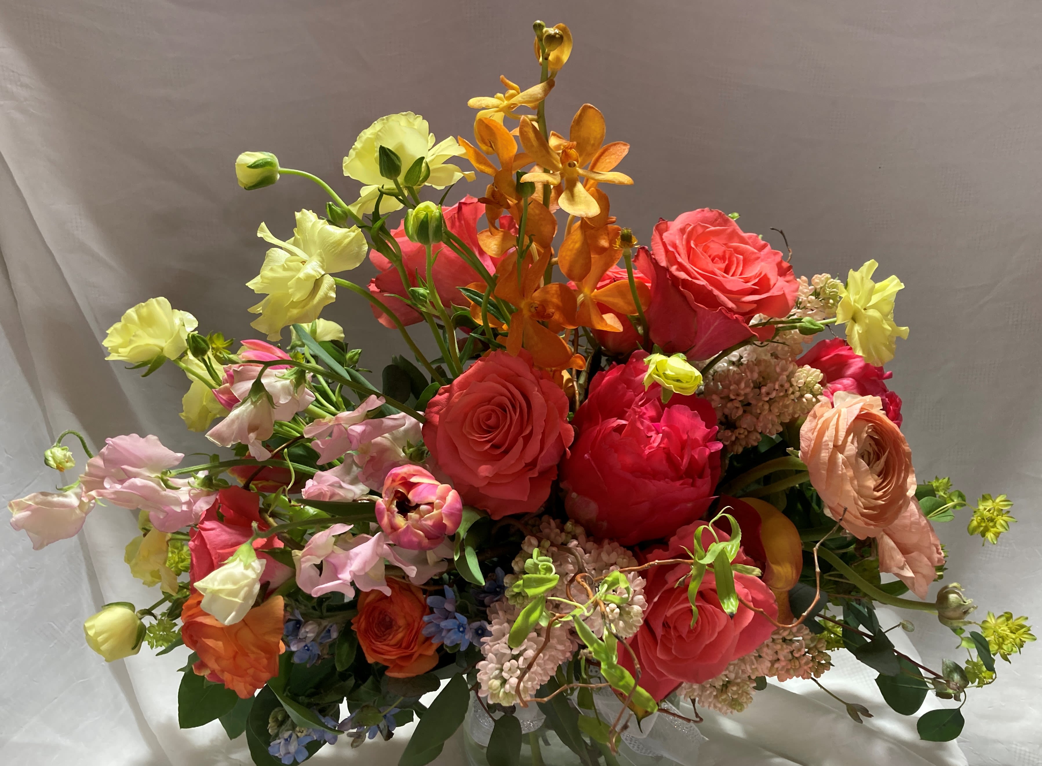Sunset bridal bouquet - A wide handtied bouquet of all your special blooms in sunset colors.
