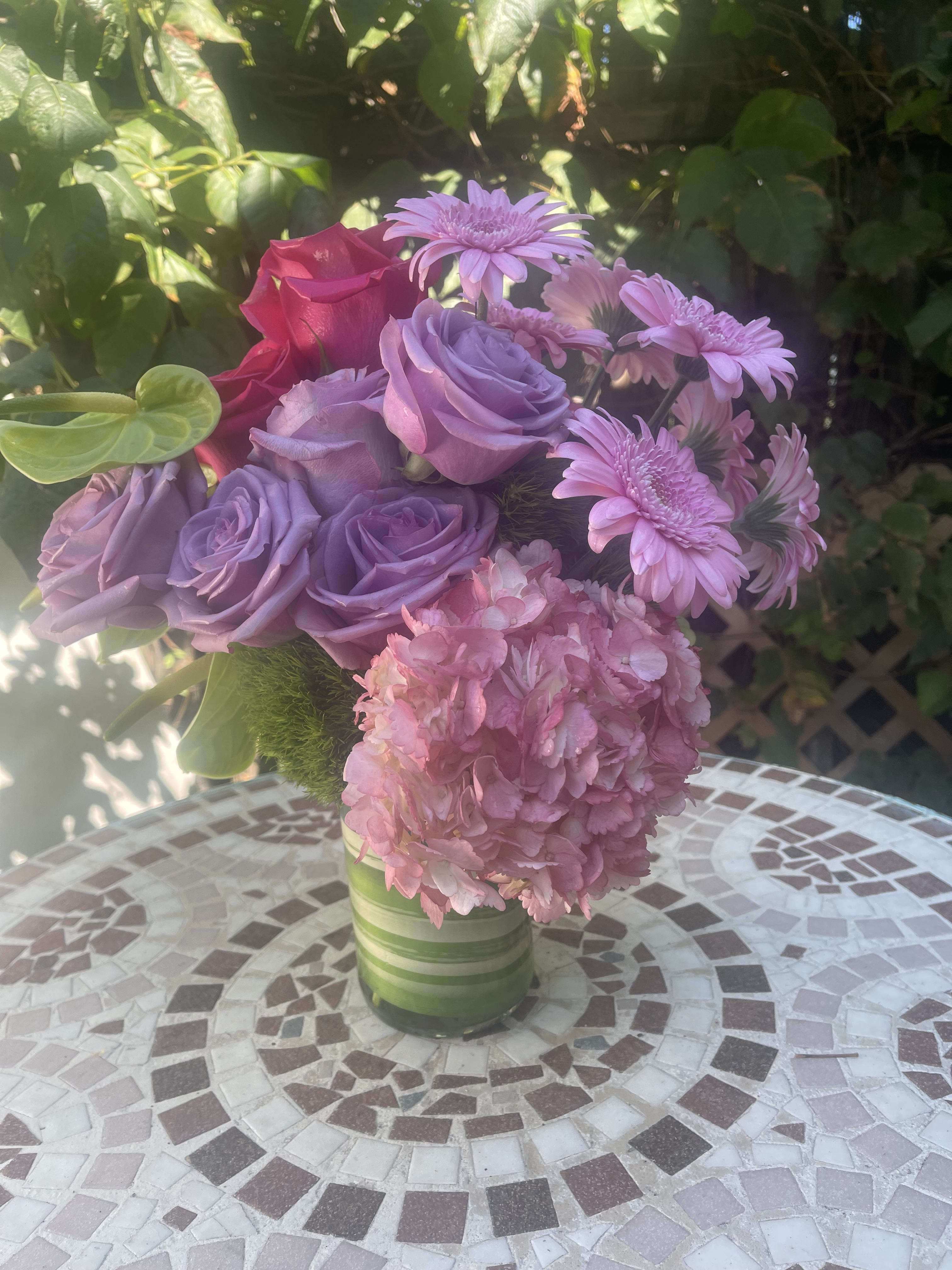A Walk in the Park - Vibrant and modern flowers perfect for an office setting, birthday, get well, holidays, or simply just because!  This cute arrangement makes a big impact!  Filled with lavender and hot pink roses, hydrangea, miniature gerbera daisy, anthurium, and green trick dianthus.  A lovely way to say I love you, goodbye, hello, thank you, or just simply &quot;just because&quot; 