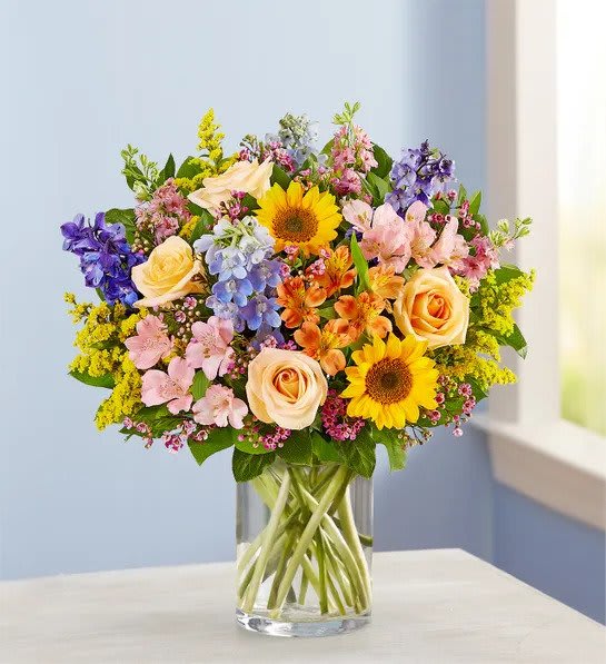 Spring Sensation - There’s so much to love about spring…but it’s the bright, beautiful blooms that make it truly sensational! Our luxurious bouquet is gathered with a garden-fresh mix in shades of pink, blue, yellow and peach. Artistically designed, this gift delivers the best part of the season right to their door.