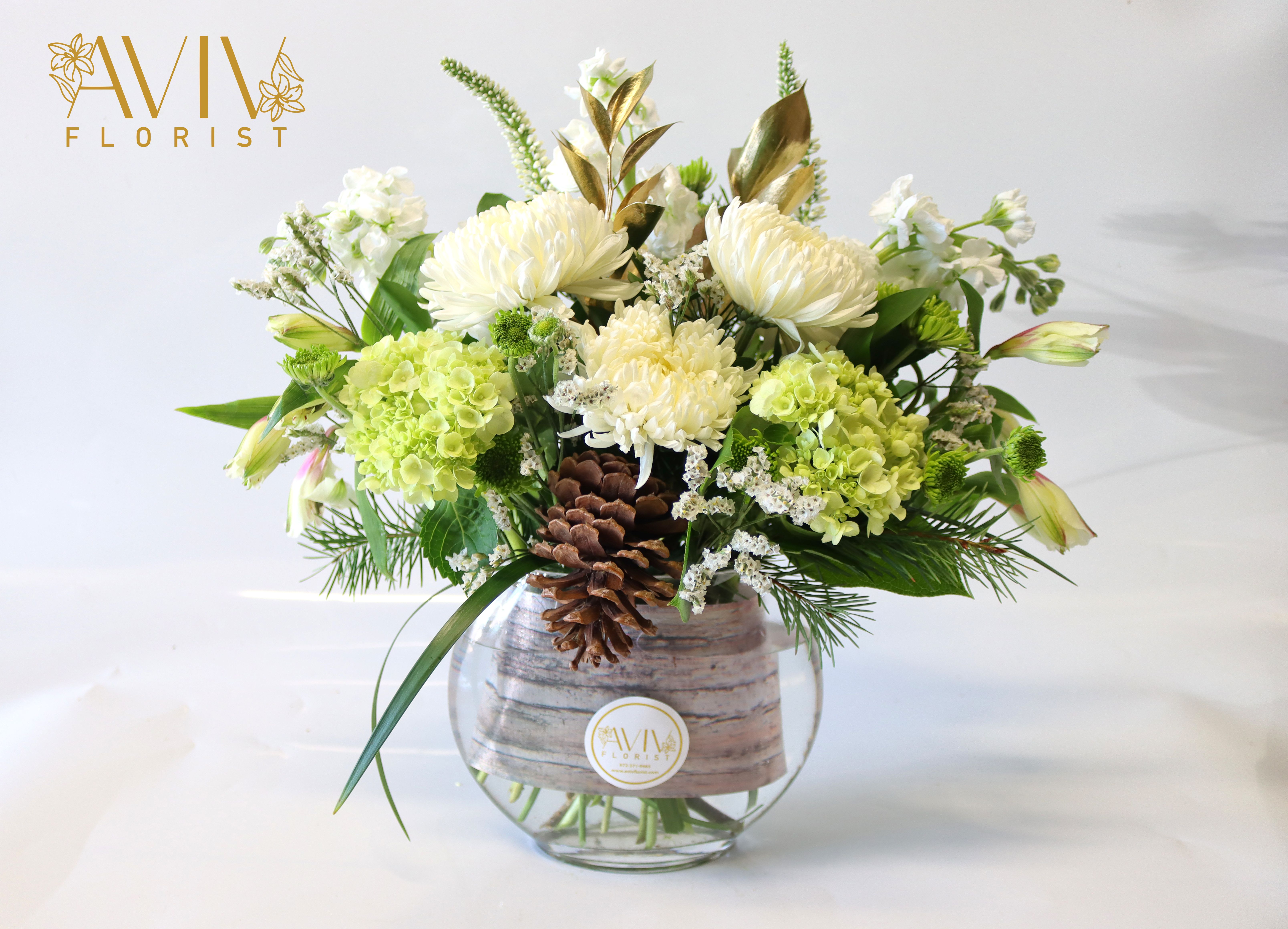 White Snow - Green Hydrangea, white cremon, white alstroemeria, white veronica, white stock, and pine with a mix of greenery.