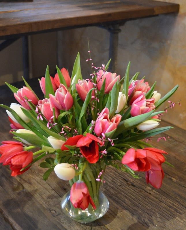 Sweet Sweet Tulips Sweet Sweet Tulips - 30 stems of luscious, joyful field tulips, arranged in clear glass with a fragrant filler flower. Color of tulips will vary with availability.