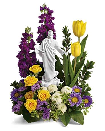Teleflora's Sacred Grace Bouquet Teleflora's Sacred Grace Bouquet - Bring a radiant reverence to any spring occasion with this yellow and purple bouquet of roses, tulips and asters surrounding a peaceful porcelain keepsake statue. This graceful bouquet features yellow spray roses, yellow tulips, purple stock, lavender matsumoto asters, white button spray chrysanthemums, lavender sinuata statice, oregonia, myrtle, galax leaves, and lemon leaf. Delivered with a Sacred Grace Keepsake.