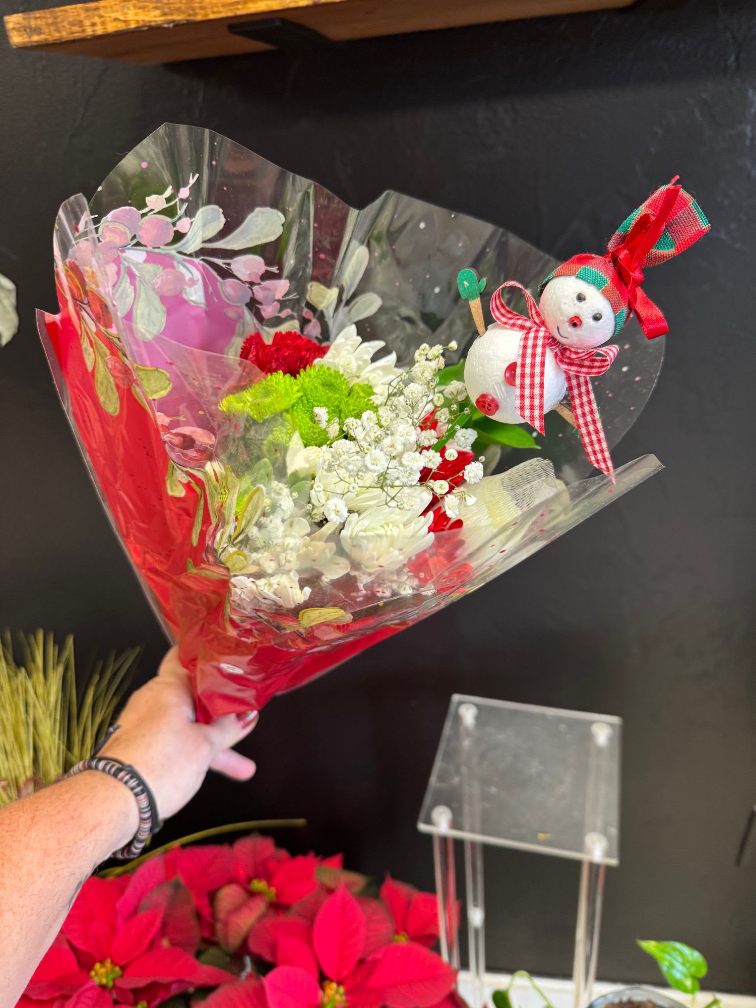 Snowman Bouquet - Embrace the spirit of the season with this festive design—complete with an adorable snowman. Choose between a bouquet (standard) and an arrangement in a glass vase with a beautiful ribbon (deluxe).