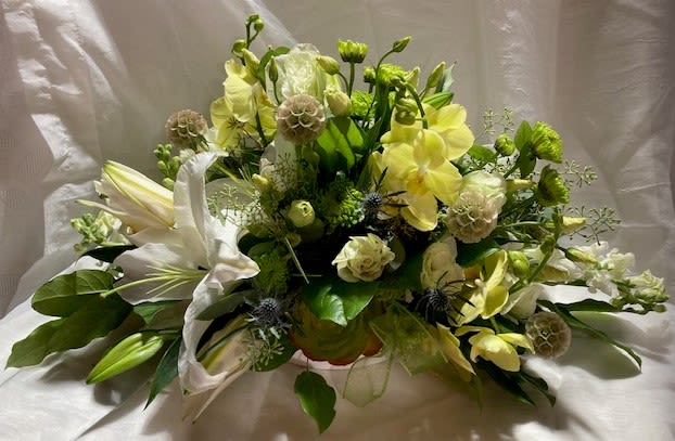 Phalaenopsis centerpiece - This large centerpiece of white oriental lilies, phalaenopsis orchids, lisianthus, succulents, snapdragons, seed pods, and others as available, is very fragrant and a gracious touch to your celebration.