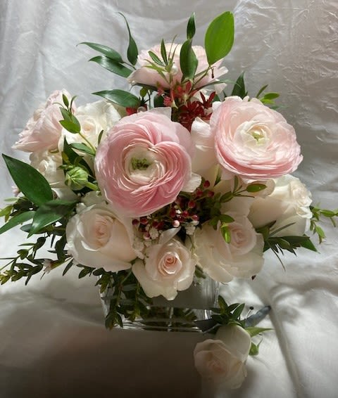 Blushing bridal bouquet and bout - If you love blush colored flowers, this hand-tied bridal bouquet and bout will make your day!  This blushing bridal bouquet includes blush roses and ranunculus.  The bouquet is delivered in a clear square vase so the bouquet can have access to water before and after the ceremony, but also so this bouquet can be a centerpiece for the reception.  The groom's bout is also a blush rose.  