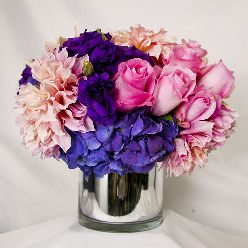 Jewel Tones - Pale pink dahlias, Esperanza roses, violet lisianthus, and purple hydrangeas pop in a mirrored glass vase. 