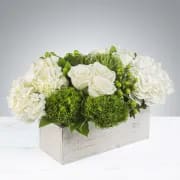 The Hamptons by BloomNation™ The Hamptons by BloomNation™ - This crisp white and green arrangement includes roses, dianthus, and hydrangeas. The Hamptons by BloomNation™ is the perfect gift for a Grandparents Day, Earth Day, or just because. It's size and shape also make it a fitting centerpiece for any table. APPROXIMATE DIMENSIONS 18" W X 10" H