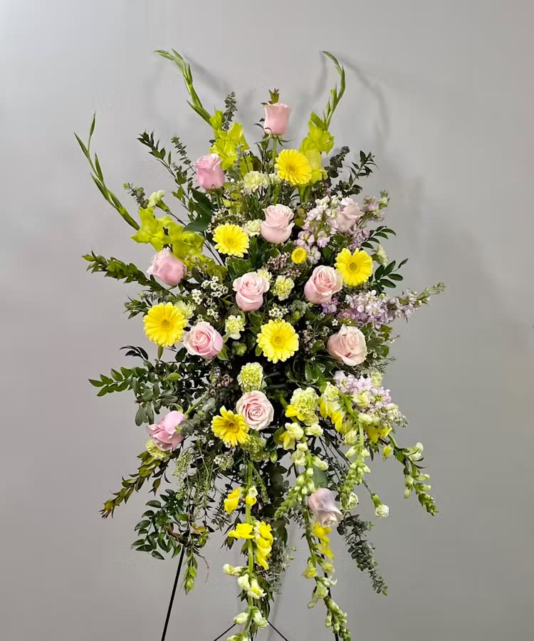 Pastel Standing Spray - If you think of her and remember sweet softness, this is the perfect choice. A standing spray of mixed pastels will bring about somber smiles when displayed at the funeral home, graveside service, or church. A perfect memorial for someone who loved soft spring pastel colors in life to celebrate them.