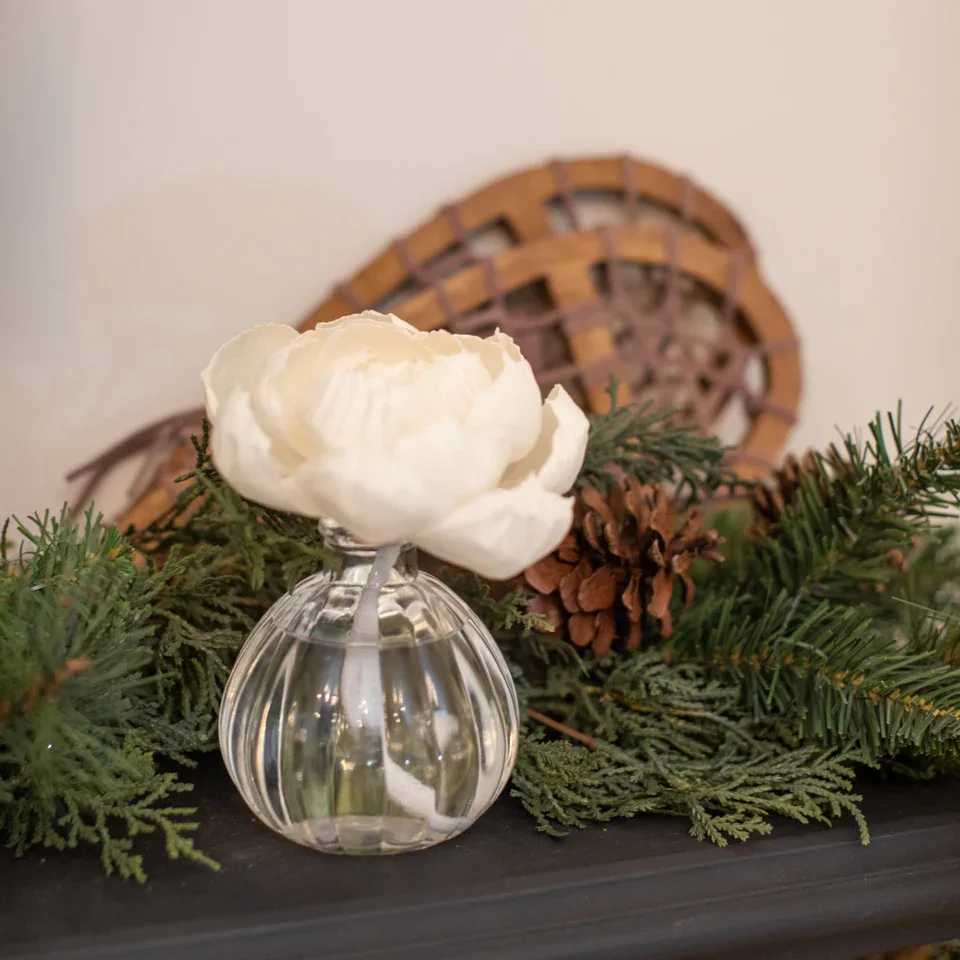 Shimmering Snowberry Flower Diffuser - Our Flower Diffuser includes your favorite Greenleaf fragrance oil and a sola paper flower that emits a beautiful, blooming scent for up to 60 days! As the fragrance oils are absorbed through the wick, the flower begins to “bloom,” slowly emitting the fragrance and eventually resembling real flower petals.   Did you Know? You can use a Refill! Bring your Flower Diffuser back to life by using the entire contents of one of our Reed Diffuser Oil Refills in the same fragrance to enjoy your Flower Diffuser one additional time after initial use.  What Makes it Special:  Beautiful fragrance created in-house by a team of professional perfumers Through Greenleaf Cares, proceeds of this product support organizations in the fight to end human trafficking  Fragrance: Shimmering Snowberry Fragrance Family: Fruit &amp; Vine Fragrance Description: Glistening with modernity, Shimmering Snowberry juxtaposes a tart glaze of grapefruit, apple and kiwi with fresh-cut bouquets of sweet jasmine and lily.  Use and Care:  Place diffuser vase on a flat, stable surface Holding glass at base, carefully twist the cork out of the container Extend the stem of the flower fully and place it into the bottle, ensuring that the wire located within the wick is fully inserted into the neck of the container Enjoy the fragrance as well as the beauty of the flower as it blooms for up to 60 days When all the oil has been diffused and the flower begins to dry out, replace your Flower Diffuser 