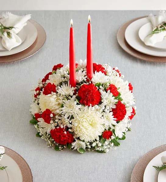 The Halls™ Centerpiece The Halls™ Centerpiece - festive Christmas centerpiece. This traditional arrangement is filled with red and white blooms, then finished off with a red taper candle or two, casting a warm glow over holiday gatherings, while adding seasonal beauty to your home. Order today, and for a limited time, get a large centerpiece for the price of a small centerpiece.