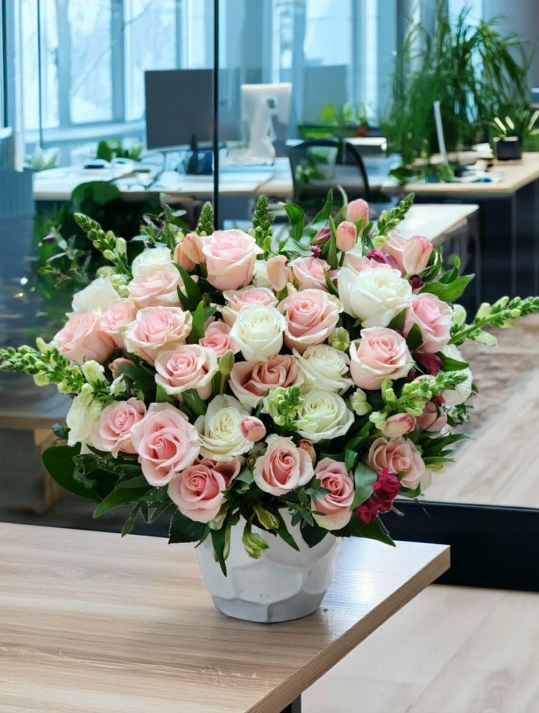 Harmony in Bloom - This stunning floral arrangement in a ceramic vase features of pink roses, pink tulips, while lush greenery completes the luxurious design. Perfect for upscale events and special occasions.