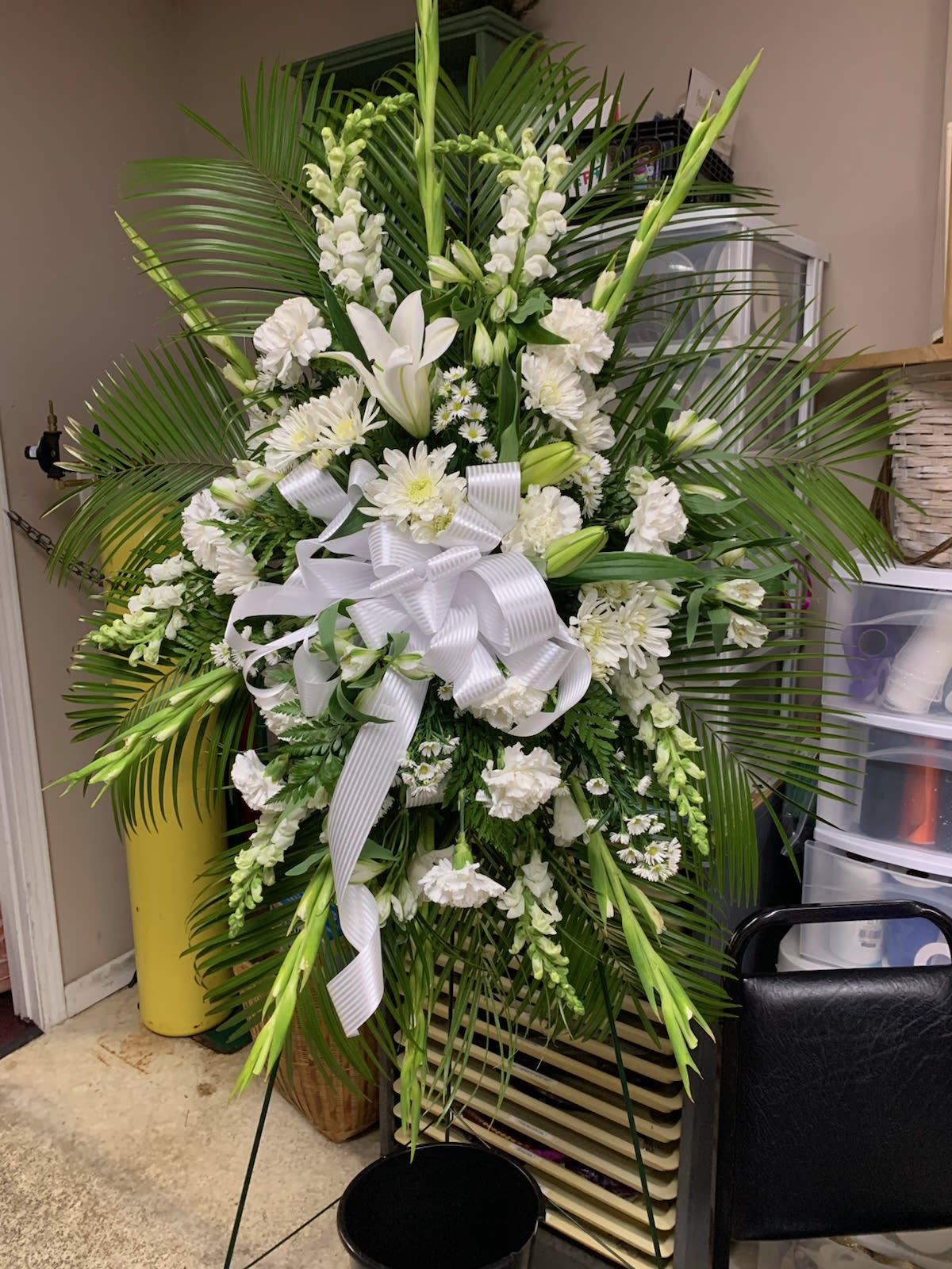 White and Green Standing Spray White and Green Standing Spray - Featuring white roses, white lilies and other white flowers with a splash of green.