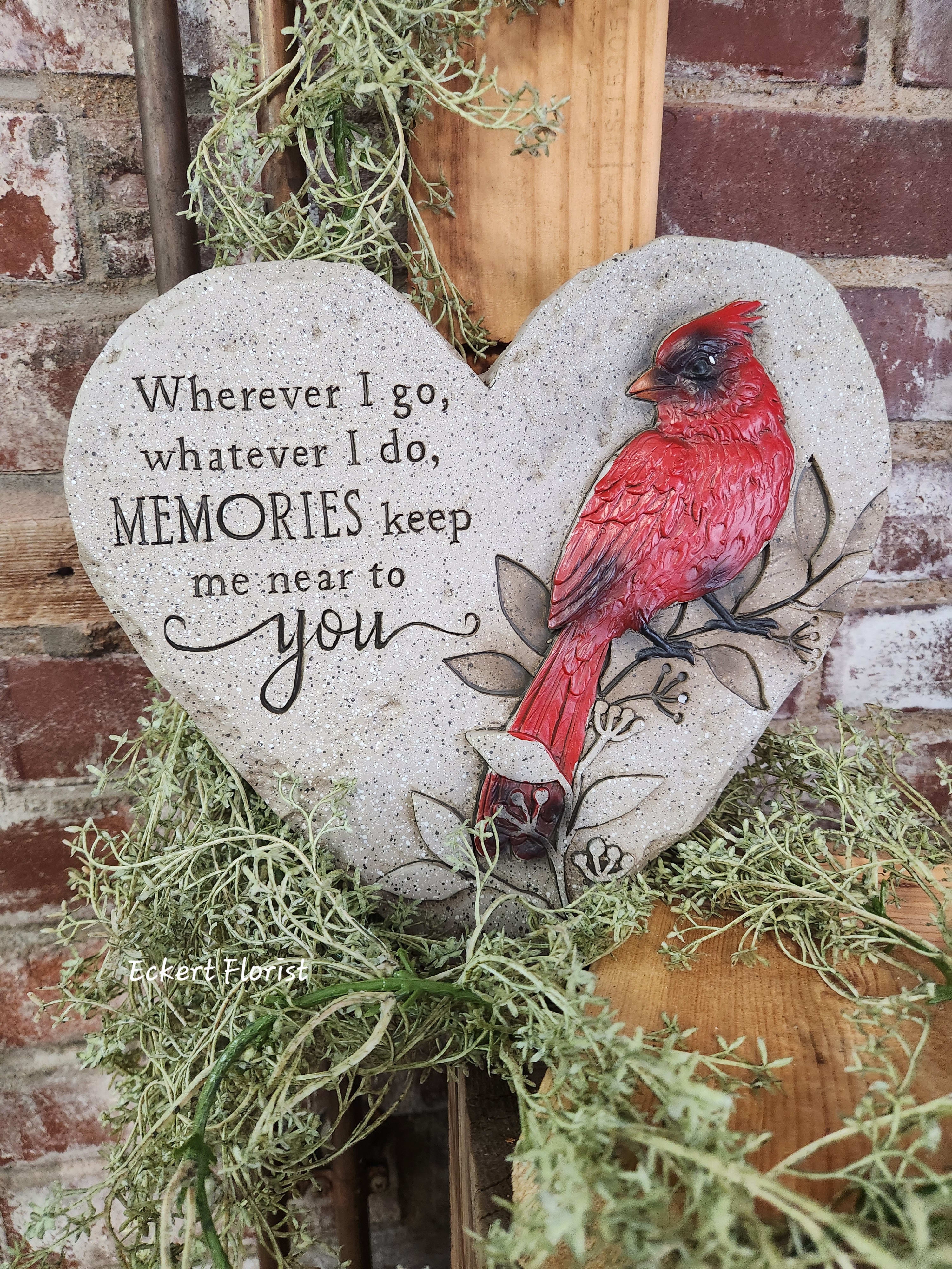 Eckert Florist's Cardinal Heart Memorial Stone Eckert Florist's Cardinal Heart Memorial Stone - **LOCAL DELIVERY ONLY* Resin heart shaped stone measures approx.10.5" W x 10" H This nice memorial keepsake may be sent to a funeral/memorial service or home. *May be added to a fresh arrangement or green plant. See Deluxe and/or Premium upgrades. *See Add-on Section for Display Easel