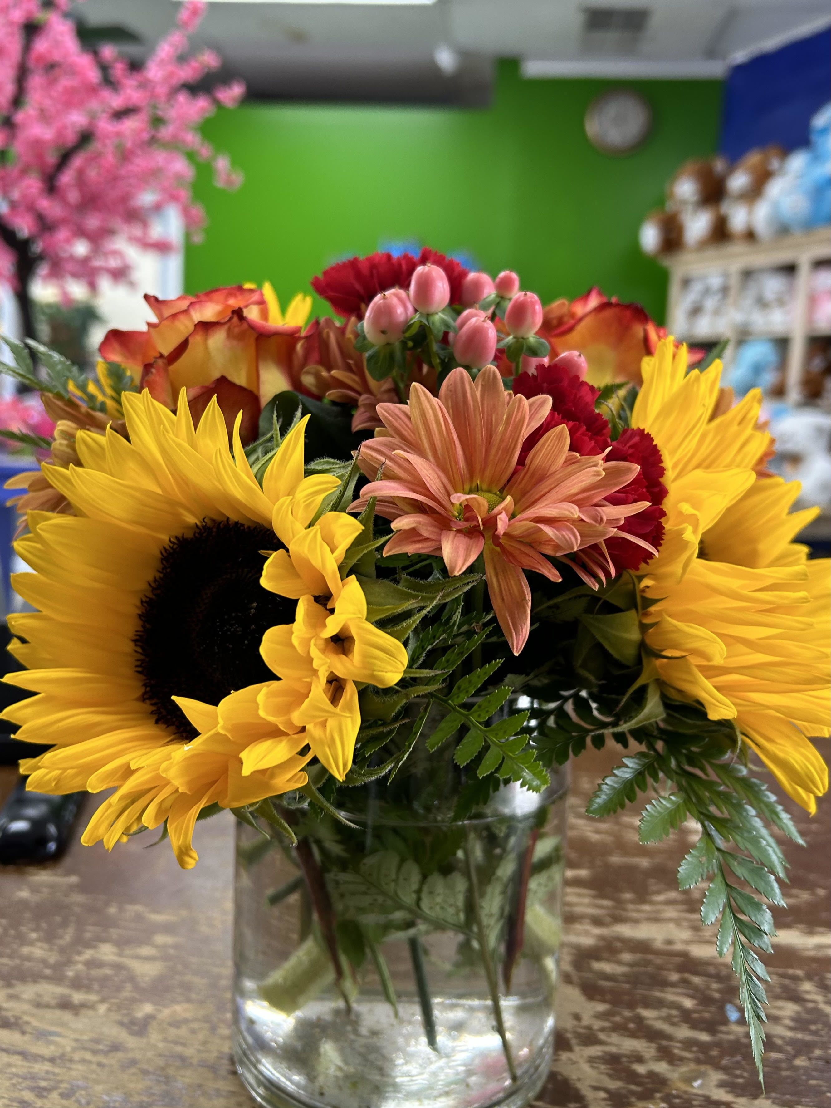 Bloom in Fall - sunflowers, orange roses, red carnations, peach Berrys,  