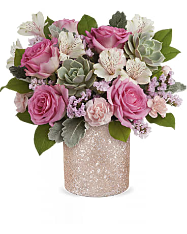 Teleflora's Shimmering Oasis Bouquet - Capture Mom's heart with our shimmering Teleflora's Blooming Brilliant cylinder, the perfect vessel for a dreamy Mother's Day bouquet, destined to be a cherished centerpiece in her home. Radiate love with Teleflora's Blooming Brilliant cylinder, complementing a dreamy Mother's Day bouquet of pink roses, ivory alstroemeria, miniature pink carnations, pink sinuata statice, dusty miller, and lemon leaf with a large green echeveria succulent, a heartfelt gesture she'll adore.