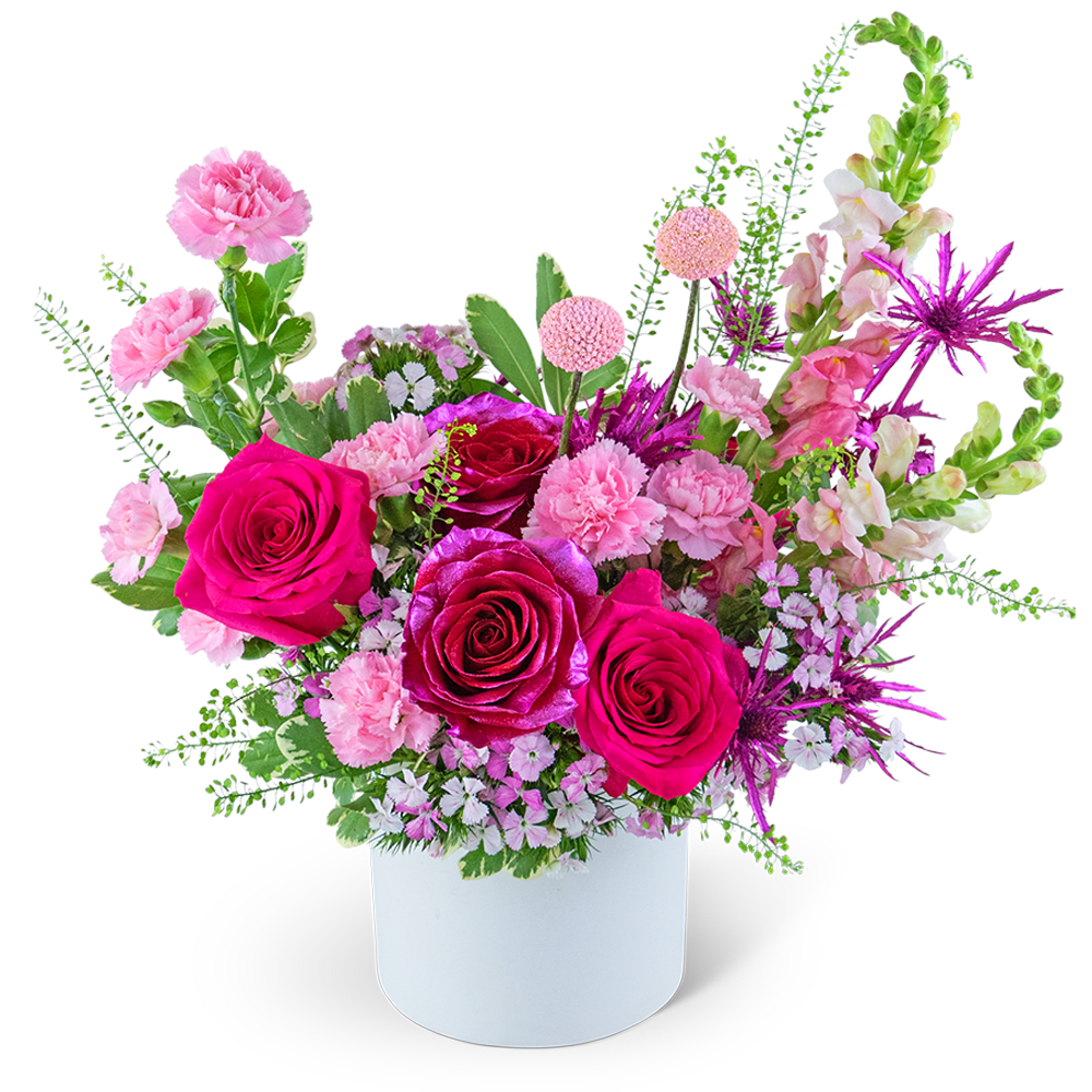 Pink Fantasy Garden - Indulge in the enchanting beauty of the Pink Fantasy Garden flower design Overflowing with delicate shades of pink, this stunning bouquet features a harmonious blend of pink and metallic pink Roses, Carnations, Snapdragons, Eryngium, Dianthus, and premium foliage. Arranged in a charming white ceramic vase, this arrangement is an exquisite choice for anyone who adores all things pink, making it a perfect gift for Valentine's Day, anniversaries, or simply to brighten someone's day with its whimsical allure.
