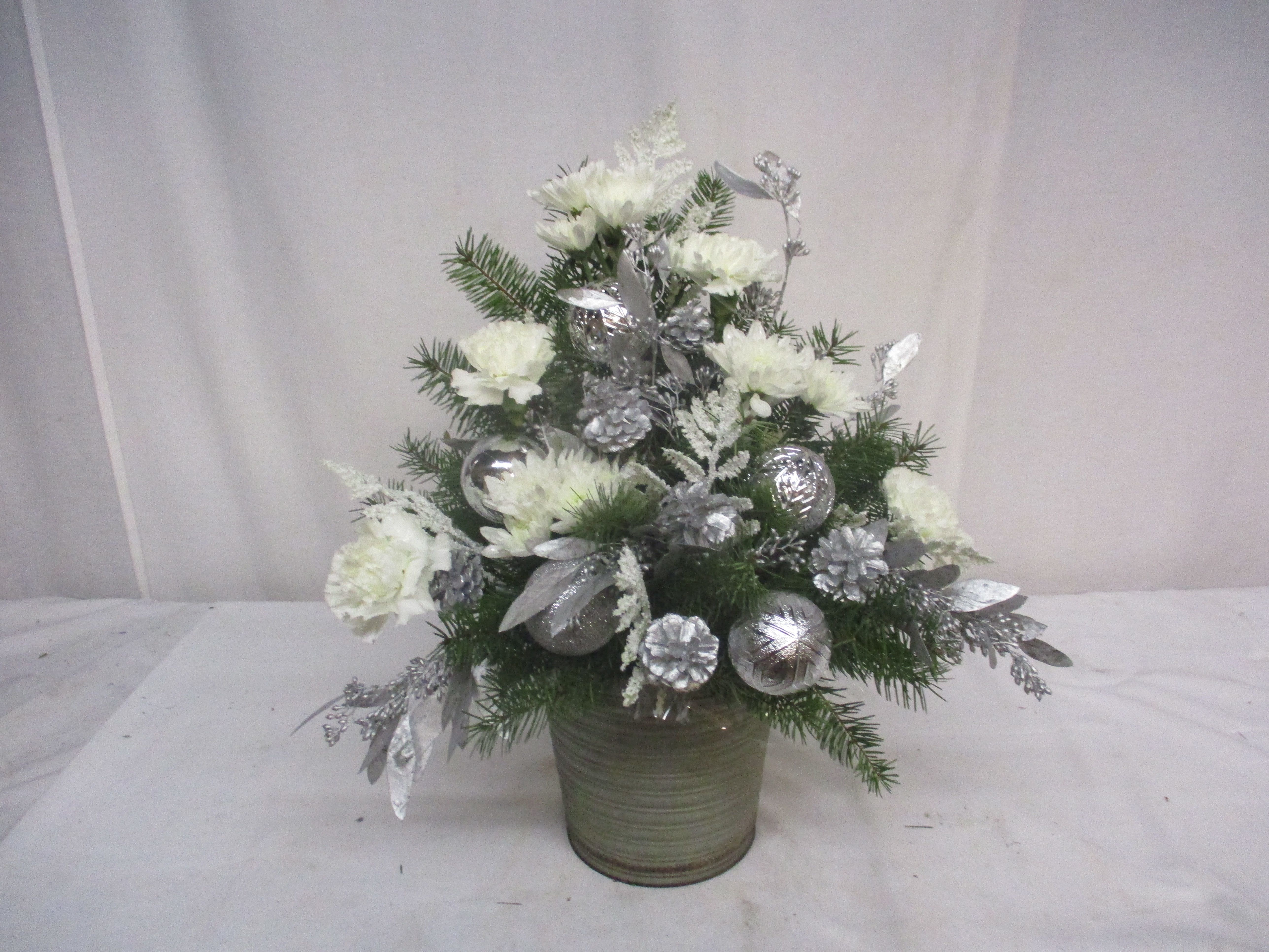 Winter Wonderland Winter Wonderland - This arrangement is a true reflection of a frozen winter wonderland. With pine, white flowers and icy branches, it is a copy of a snowy, wintery day.