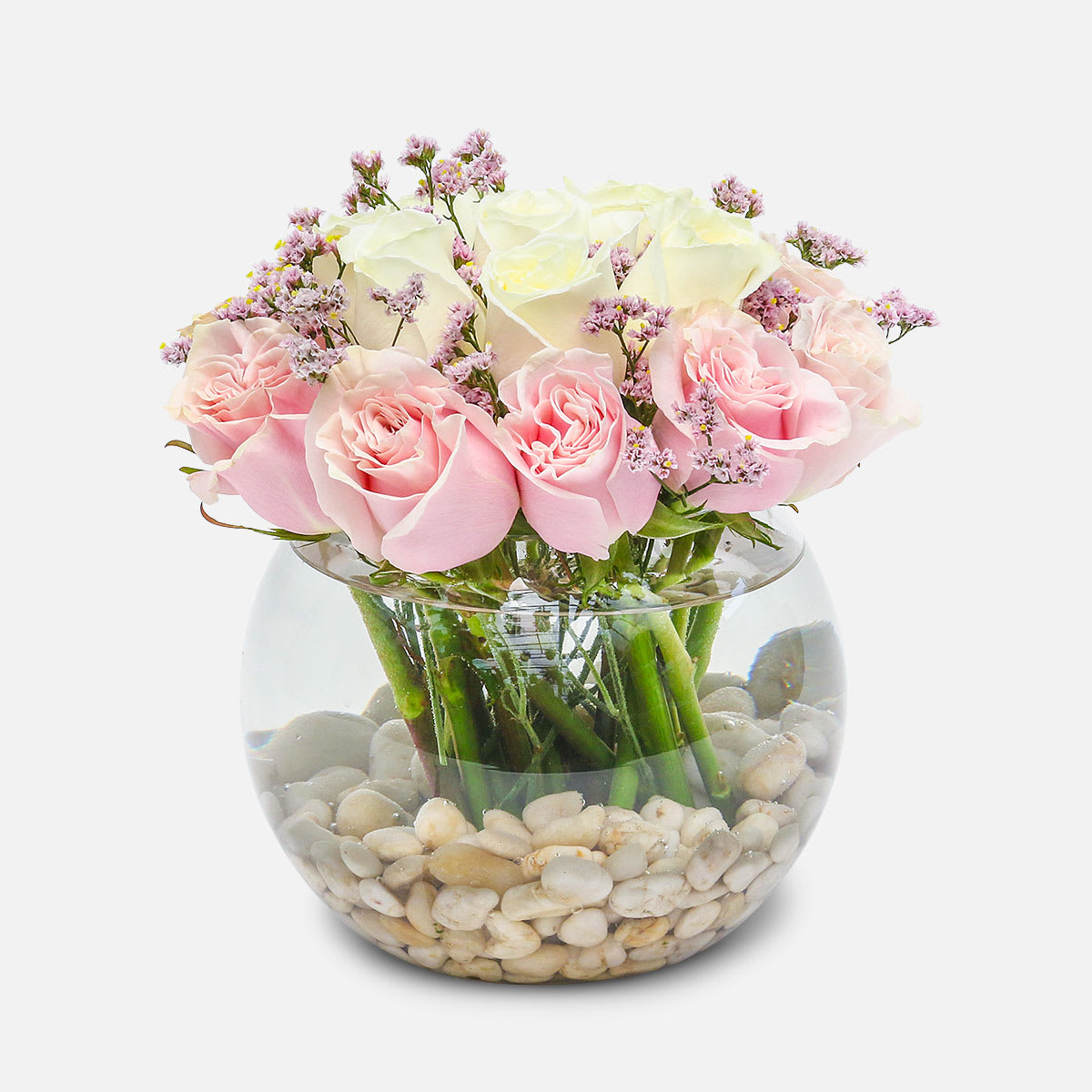 Pristine - [ Height: 10'' - 11'' | Diameter: 10'' - 11'' ] A delicate gathering of pale pink and white roses, thoughtfully arranged with a few stems of light pink statice, in a clear fish bowl. This simple, yet modern arrangement is sure to put a serene smile on their face!   PlantShed offers same-day flower delivery to any borough of NYC.