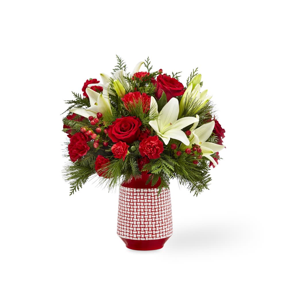 18-C1 - Hues of red are contrasted with bursts of white to make a bouquet that is sweet and beautiful. With classic red roses and red carnations, the bold white Asiatic lilies give the Sweet Joy Bouquet a refined look that will leave the recipient with a smile on their face. The red ceramic vase they arrive in boasts a raised white woven pattern