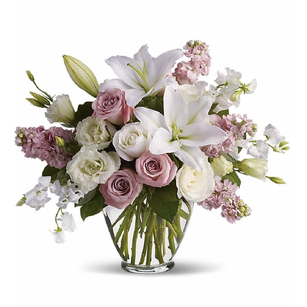 Isn't It Romantic - Tonight will certainly be romantic if you send this classic arrangement today! Beautiful hues and gorgeous blossoms will deliver your love. A stunning arrangement of light pink roses, white roses, lilies, lisianthius and sweet pea, plus pink stock make this one of our most desired selections.