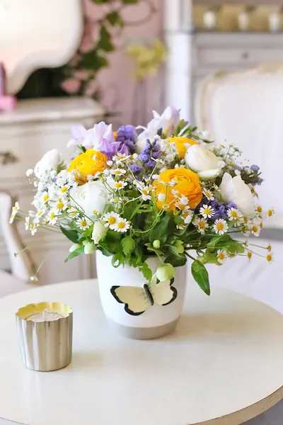 Wildfower Whimsy Wildfower Whimsy - Featuring sunny yellow ranunculus, delicate daisies, and soft lavender accents, this bouquet evokes a carefree nature charm.